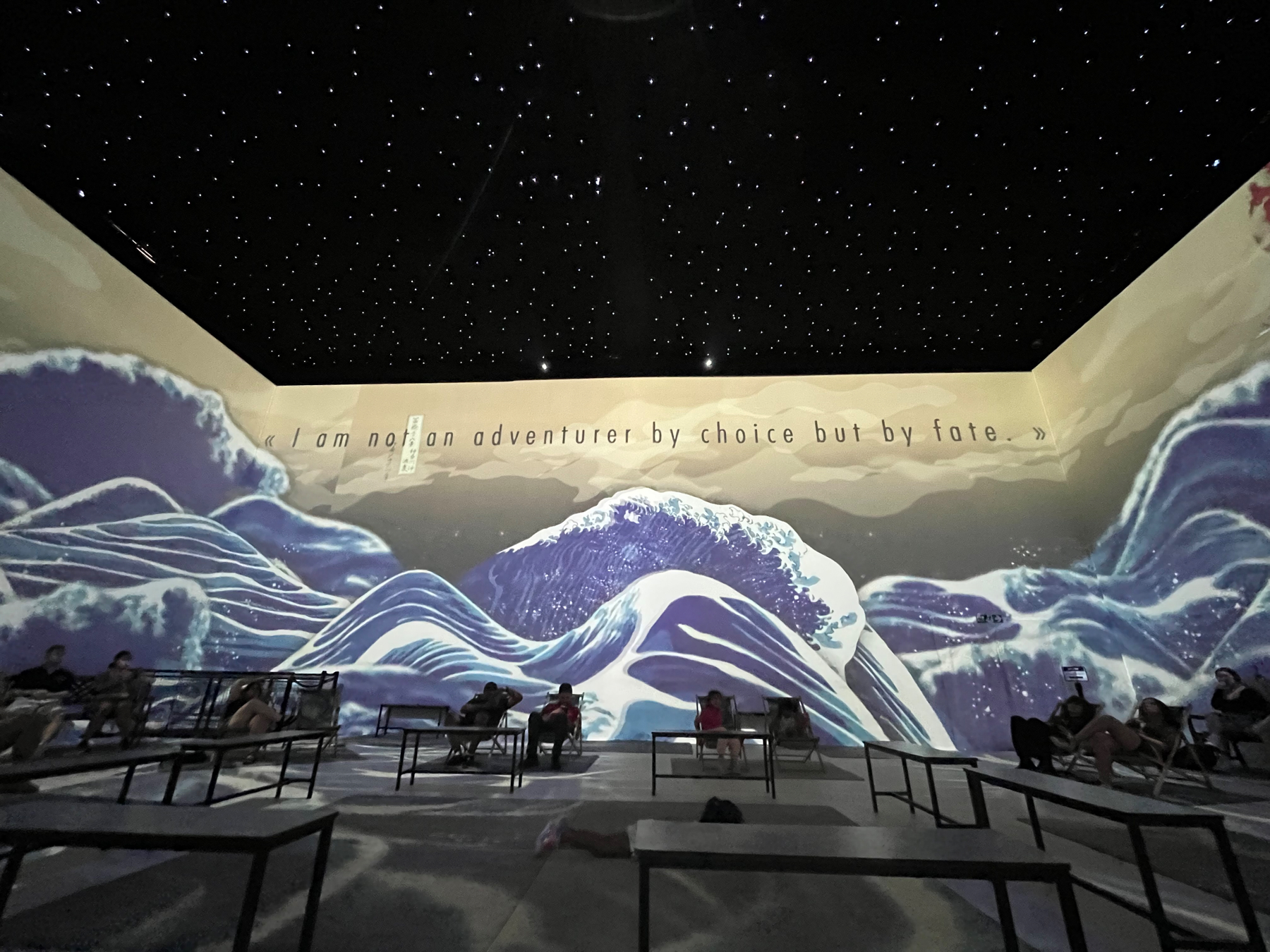 Some waves from a Van Gogh painting projected onto the walls of the exhibition