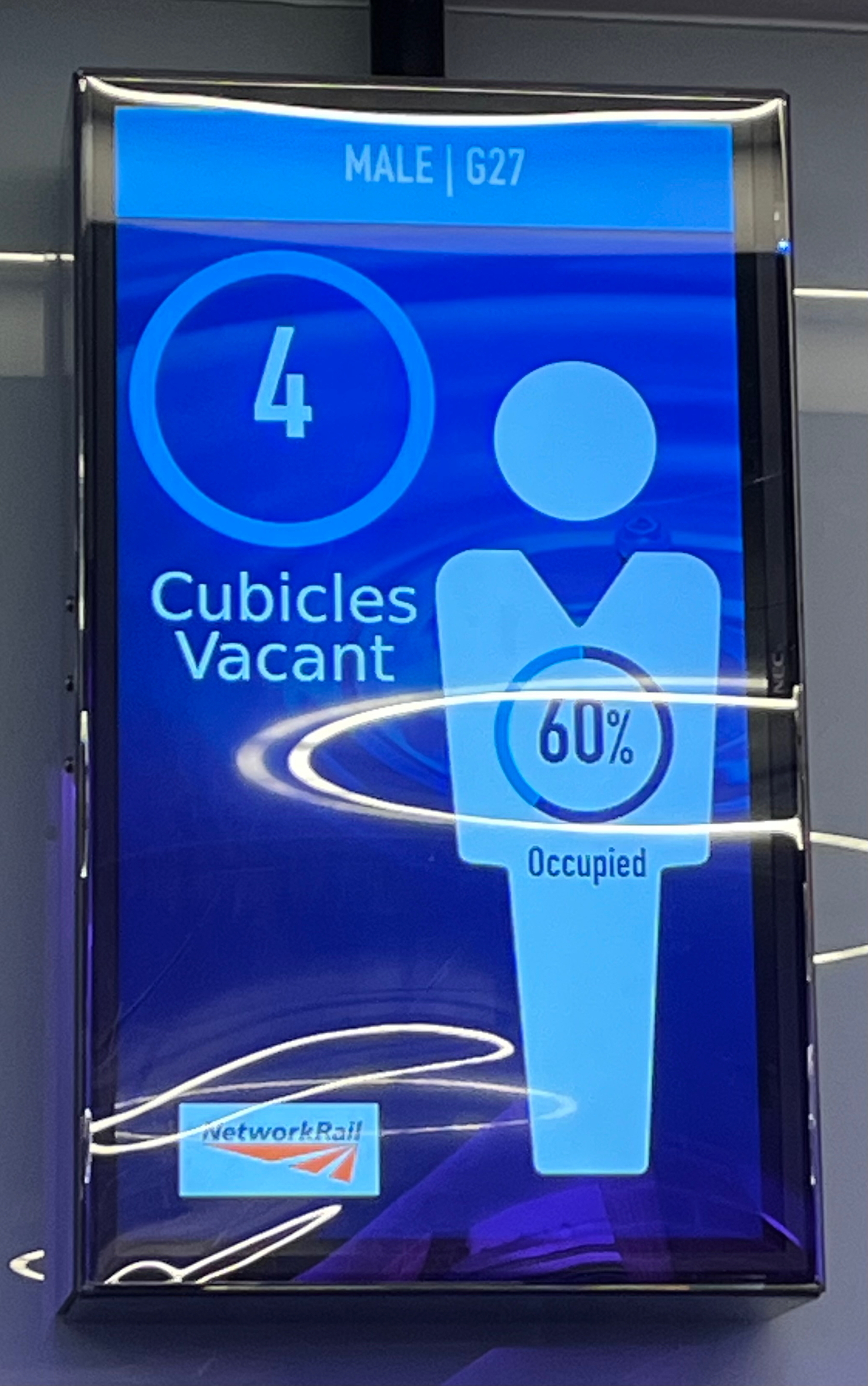 Sign displaying number of vacant cubicles in a public toilet block