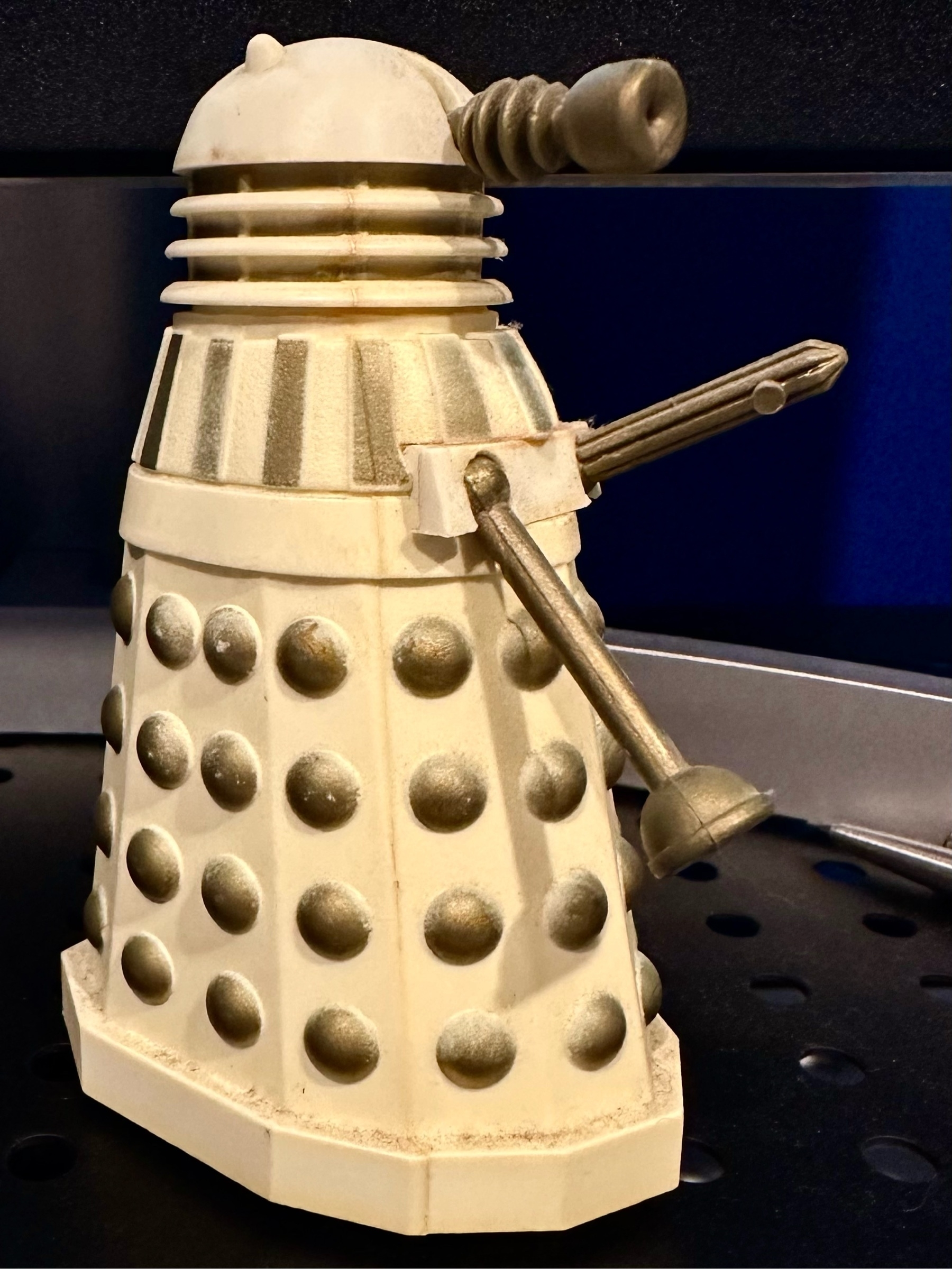 A white Dalek with gold markings from the tv show Doctor Who.