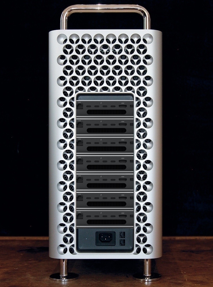 Seven M2 Mac minis stacked in a 2019 Mac Pro case as seen from the back.