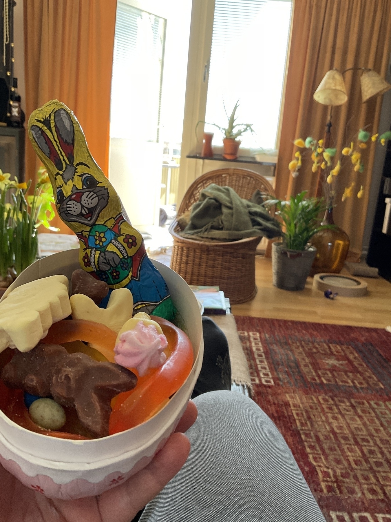 Easter egg with candy and a chocolate rabbit. 