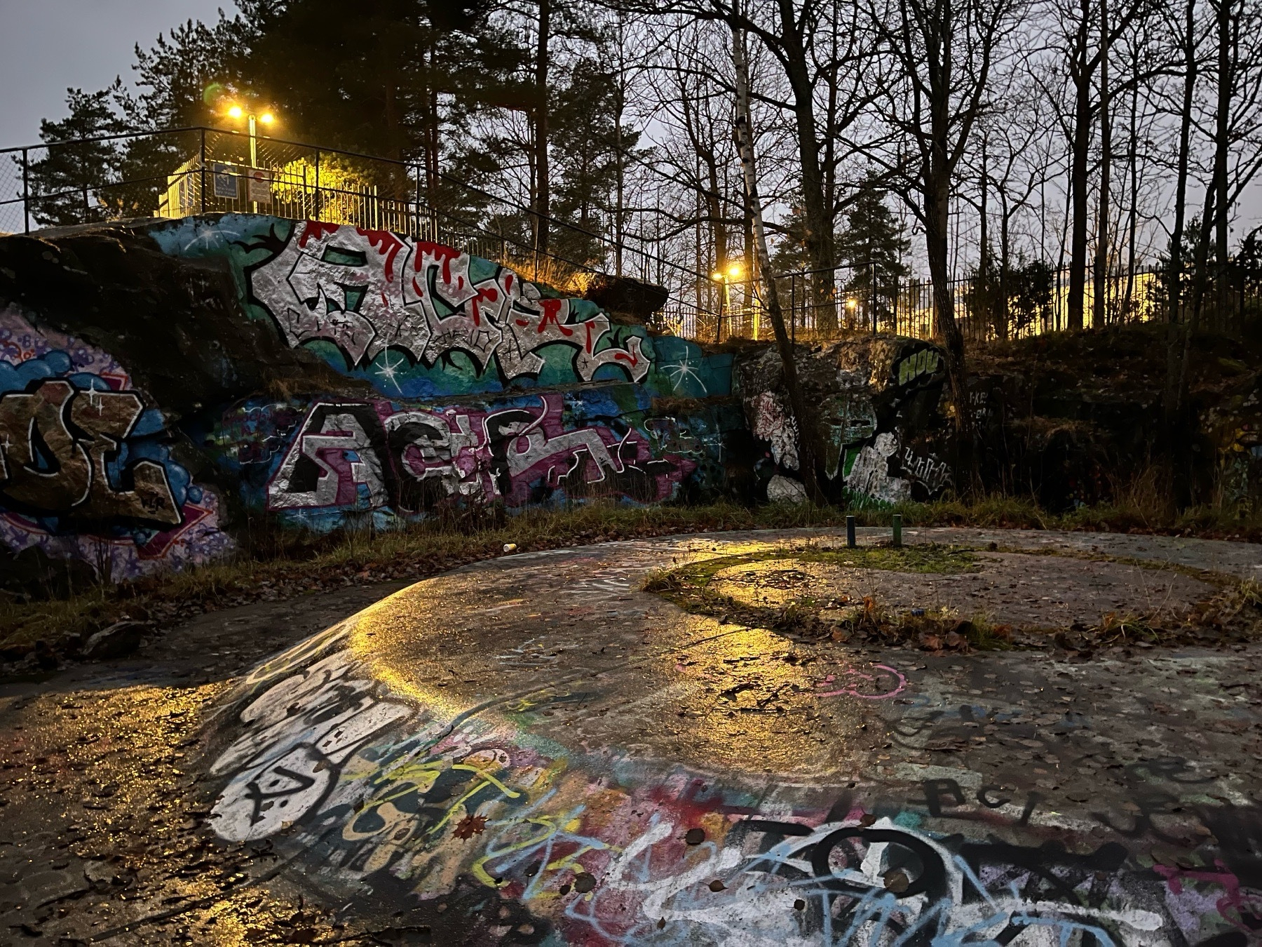 Graffiti covered concrete foundation of an old artillery bunker in dusk