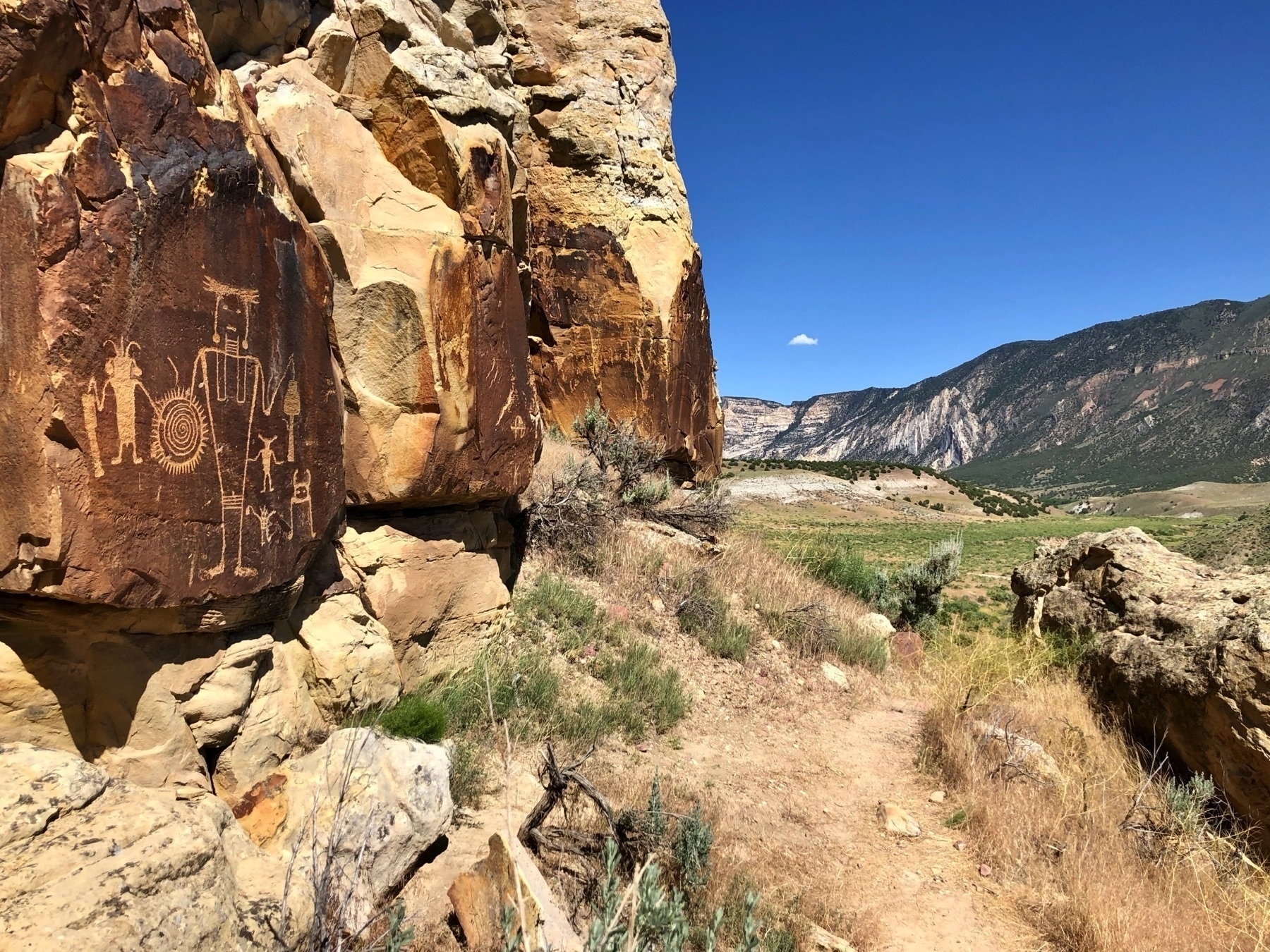 Fremont Culture petroglyph on a rock face on the left with a great view of a valley to the right. Dinosaur National Monument, Utah side.