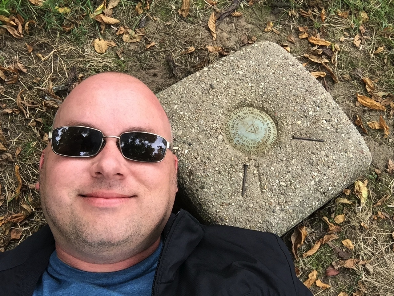 Me laying next ot the USGS marker