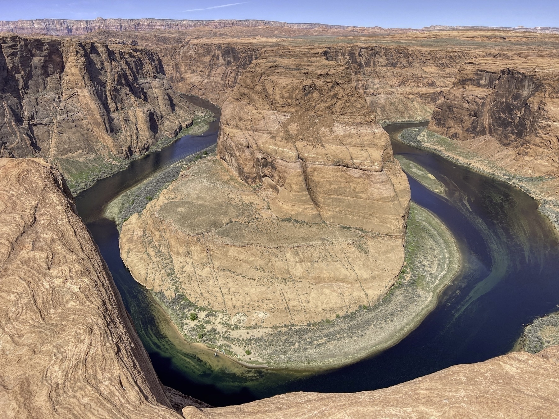 Horseshoe Bend in Arizona - the Colorado River incised a deep gorge in the red sandstone and has created a big looping bed in the foreground.