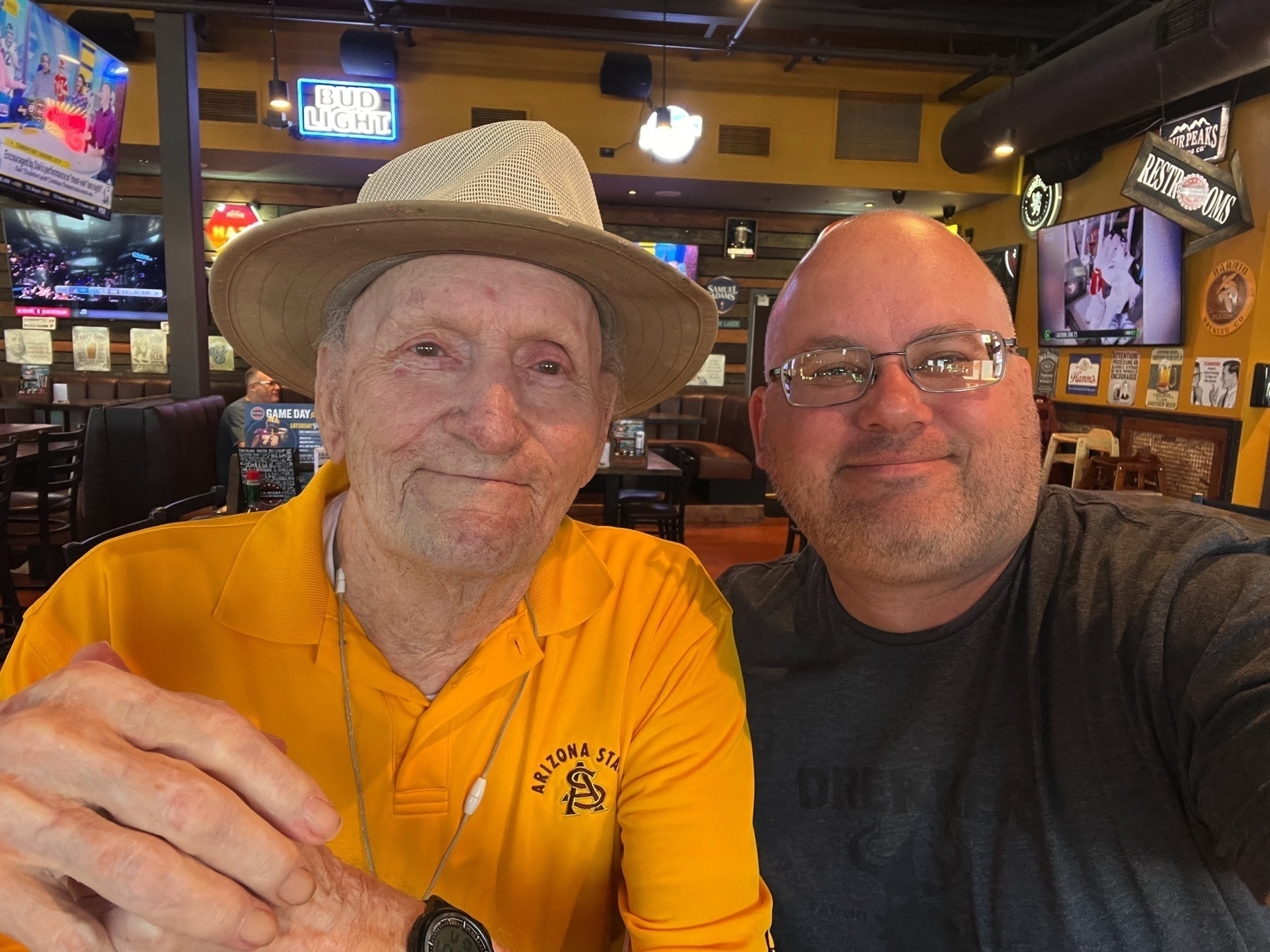 My dad and I, smiling at our local bar.