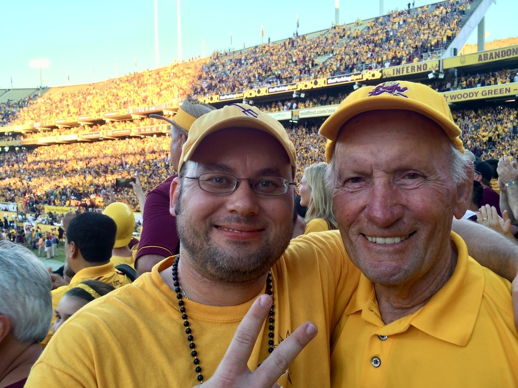 My dad and I dressed in gold in Sun Devil Stadium 