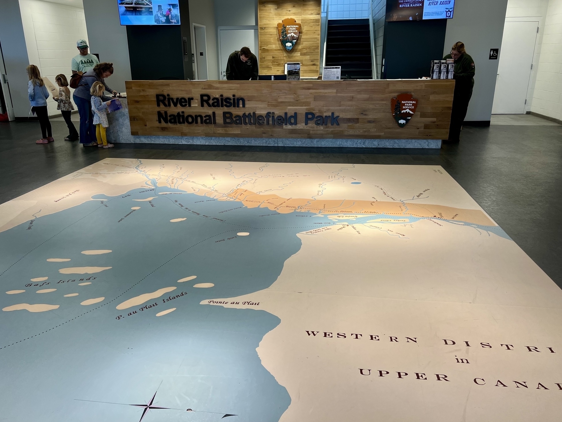 A large map on the floor depicts the Western District in Upper Canada inside the visitor center of River Raisin National Battlefield Park.