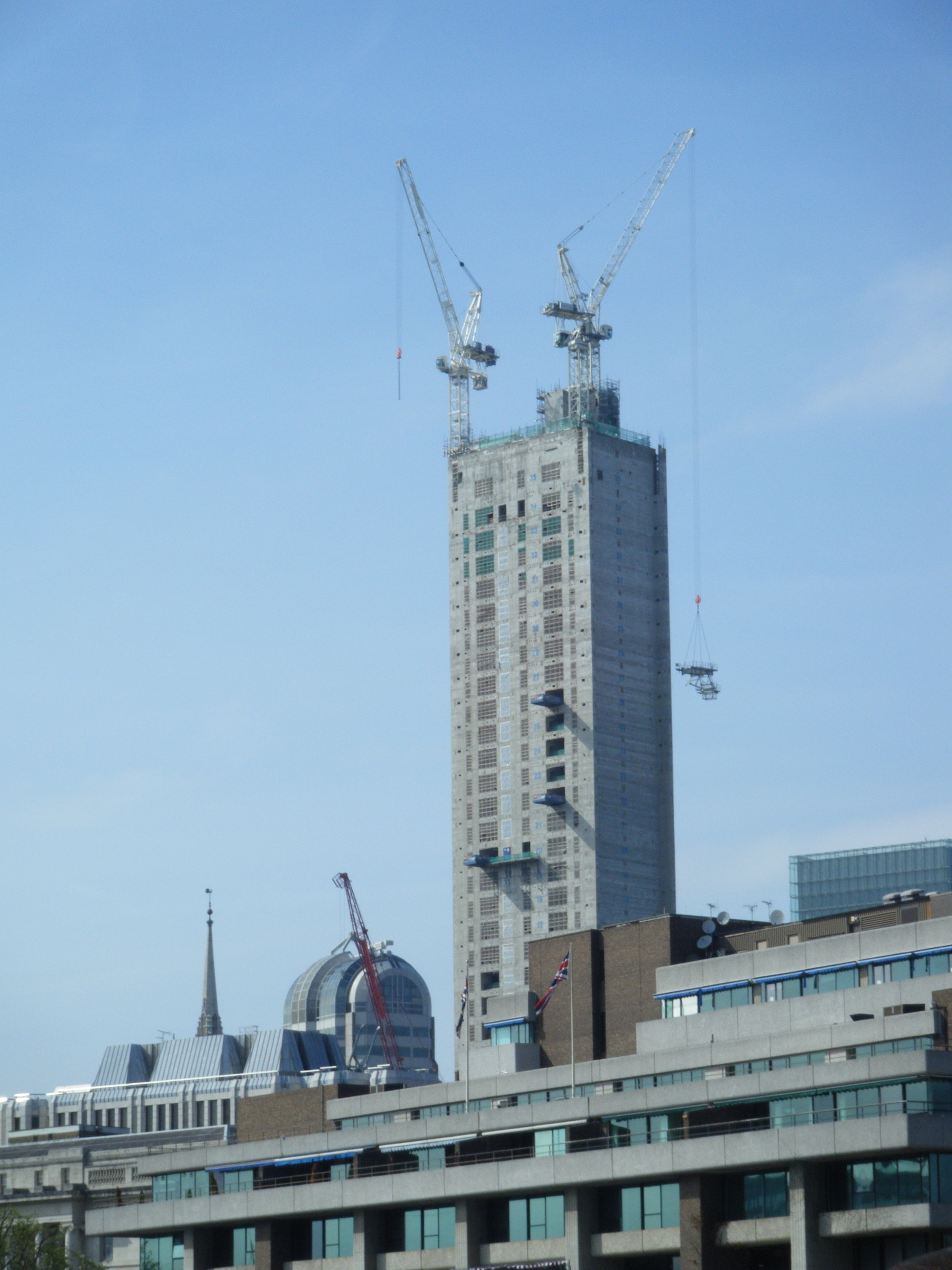 Building surrounded by cranes, London UK