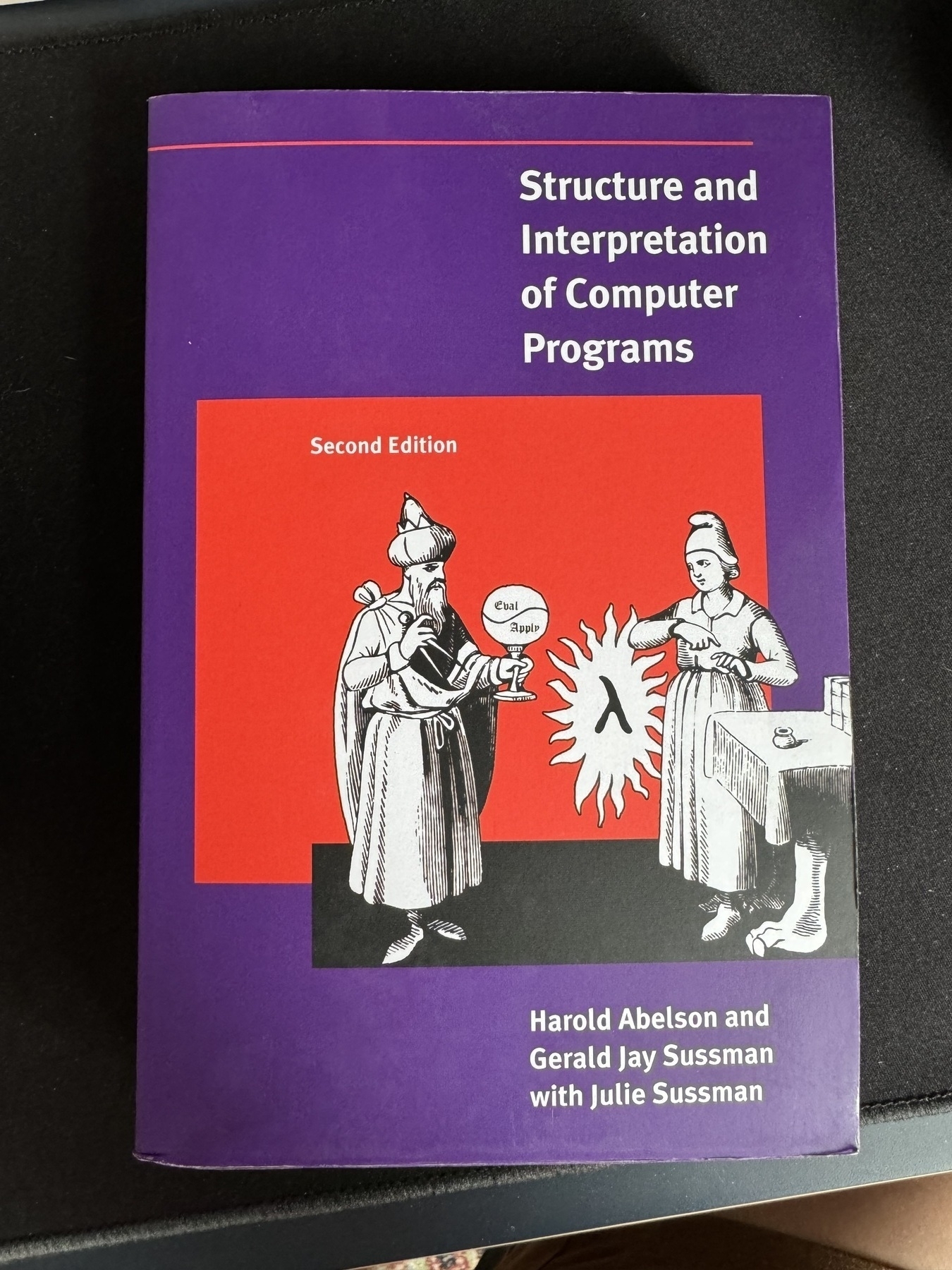 A photo of the front cover of the paperback version of “Structure and Interpretation of Computer Programs”.