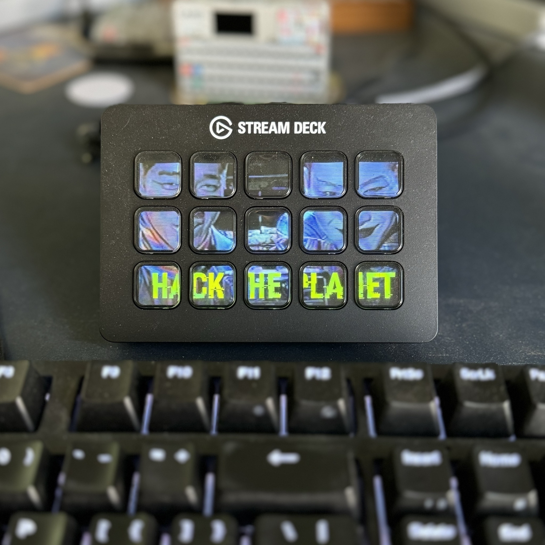The Stream Deck sitting on my desk has a background of Razor and Blade from the movie “Hackers”, captioned “HACK THE PLANET”.&10;&10;The dust blowing in today gives the patina of a Cyberpunk 2077 nomad’s table.