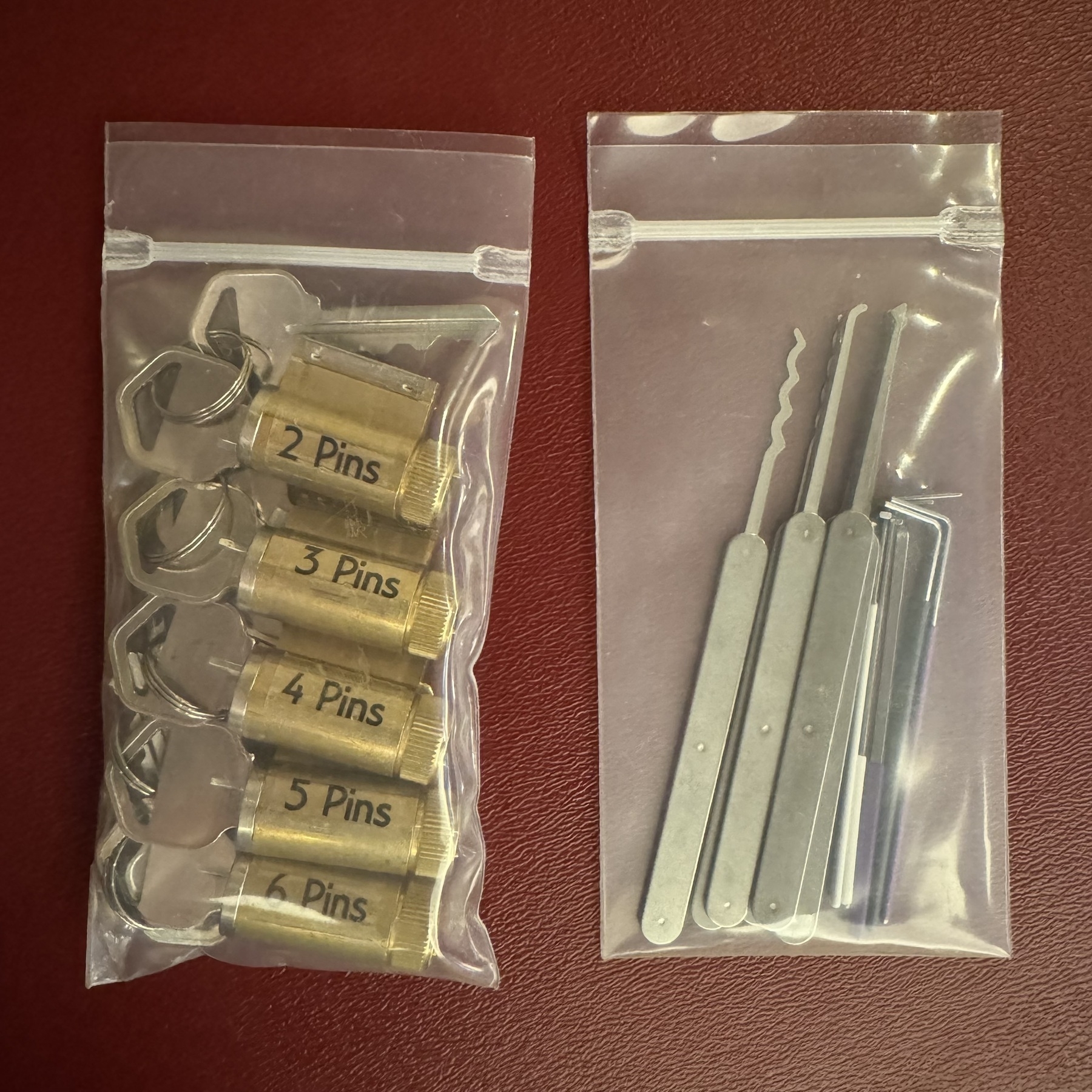 A bag of 2-6 pin tumbler locks, and a bag of assorted lock picks.