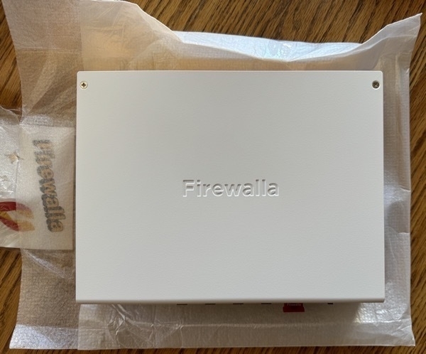 A white metal box with 'Firewalla' embossed in the top