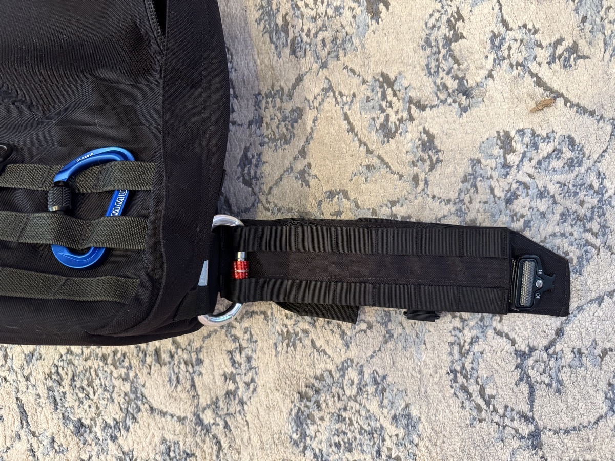 IMG_2463.jpeg Front view of the extending out from the side of the bag, with the carabiner visibly holding them together.