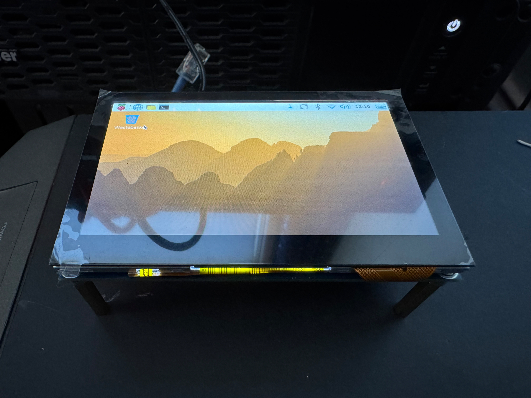 Photo of the 4.3in screen booted into a Linux desktop.