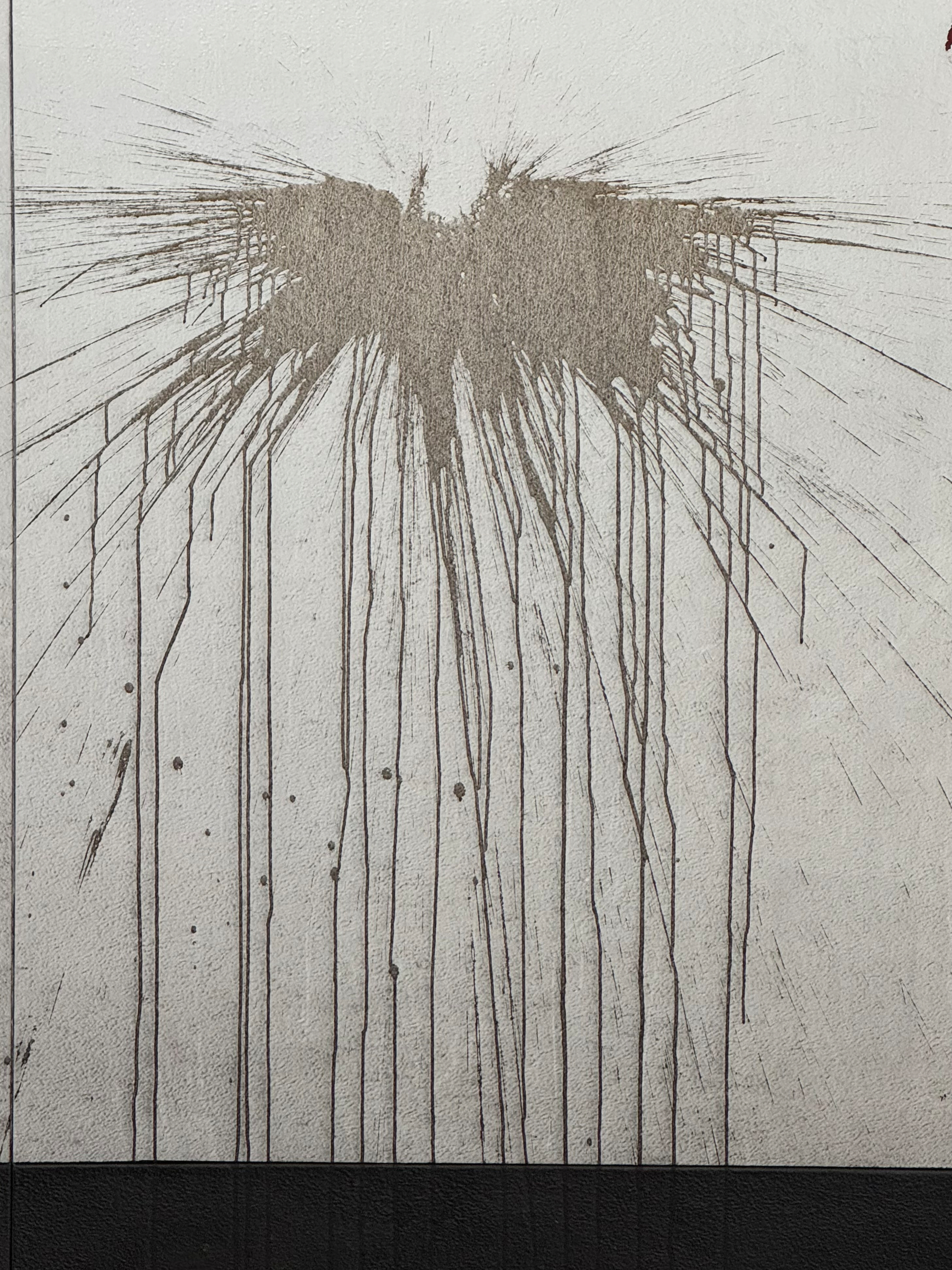 Photo of a brown stain on a dirty white wall. It looks like someone threw a chocolate shake at a subway wall. Amid the splatter and streaking is the outline of an angel with great, ragged wings, arms raised, head thrown back, crying out for mercy.
