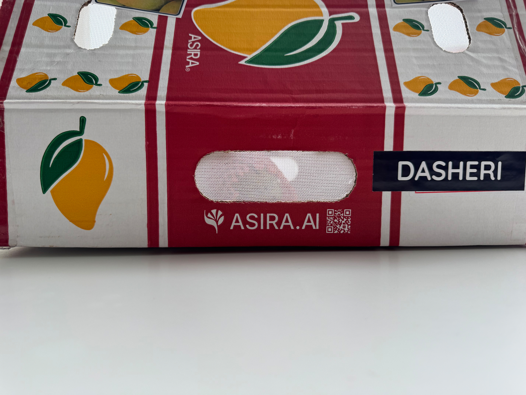 Photo of a box of mangoes with the “asira.ai” domain name printed on the side.