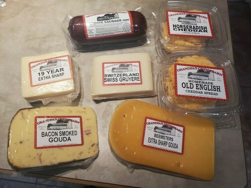 A variety of cheese laid out for inspection.