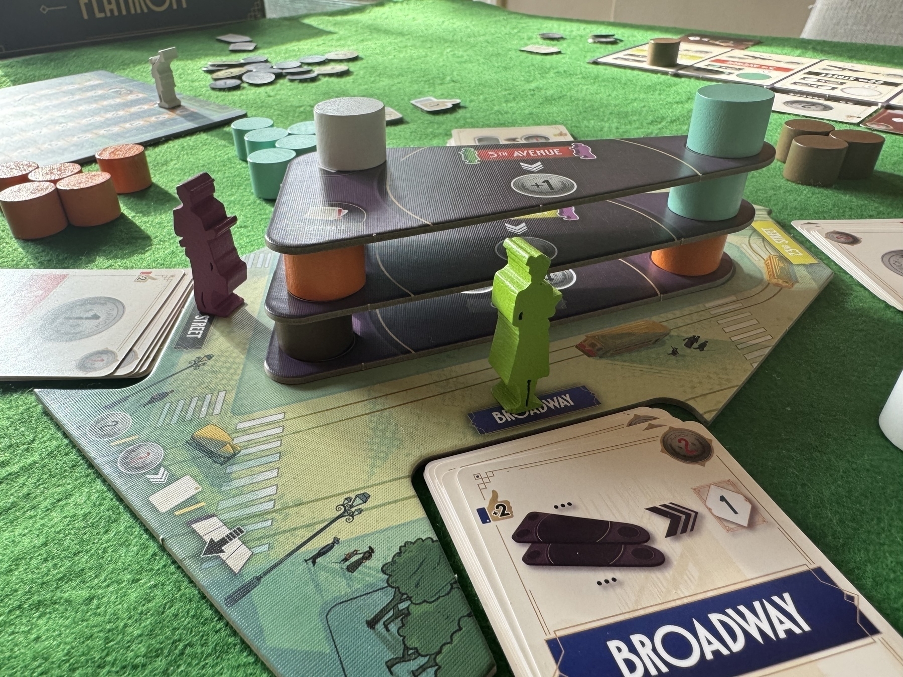 A side view of the Flatiron building be constructed in the board game Flatiron 