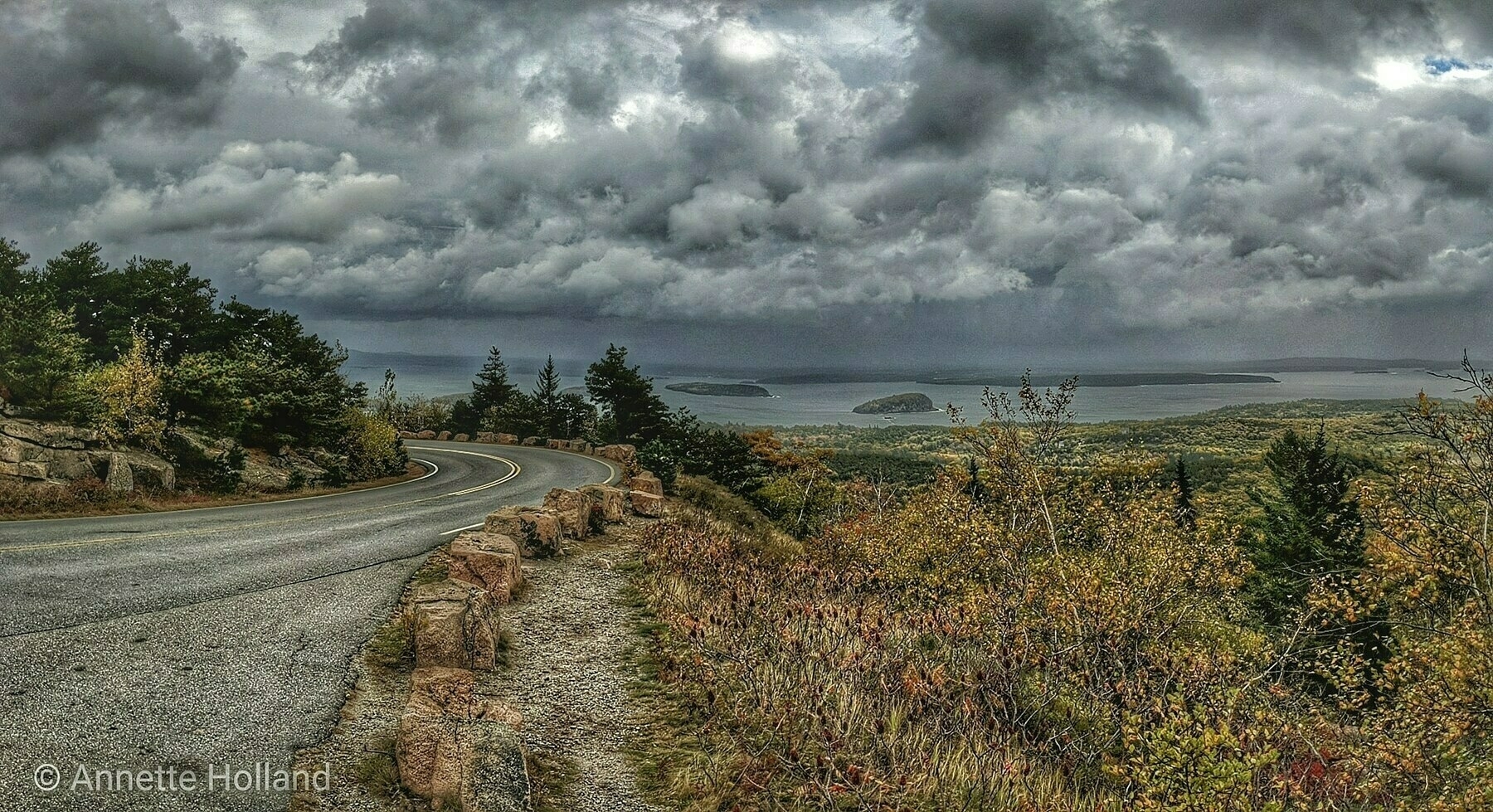 Curvy mountain road under a stormy sky. 