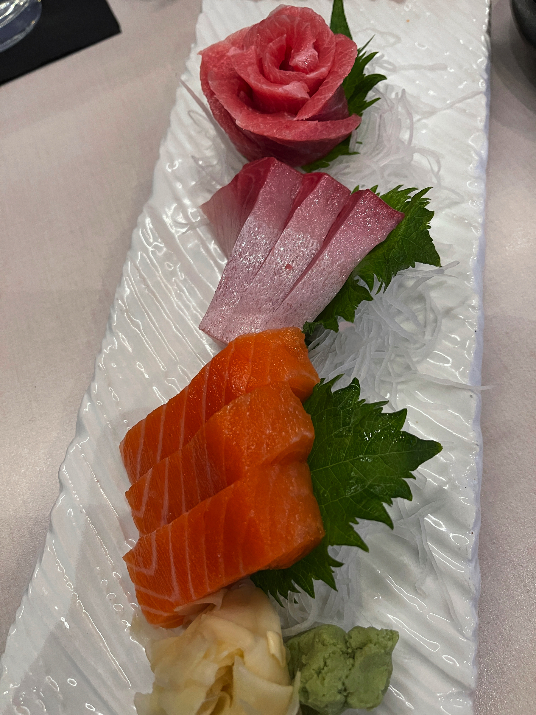 Slices of sashimi - salmon, tuna, ginger, wasabi.