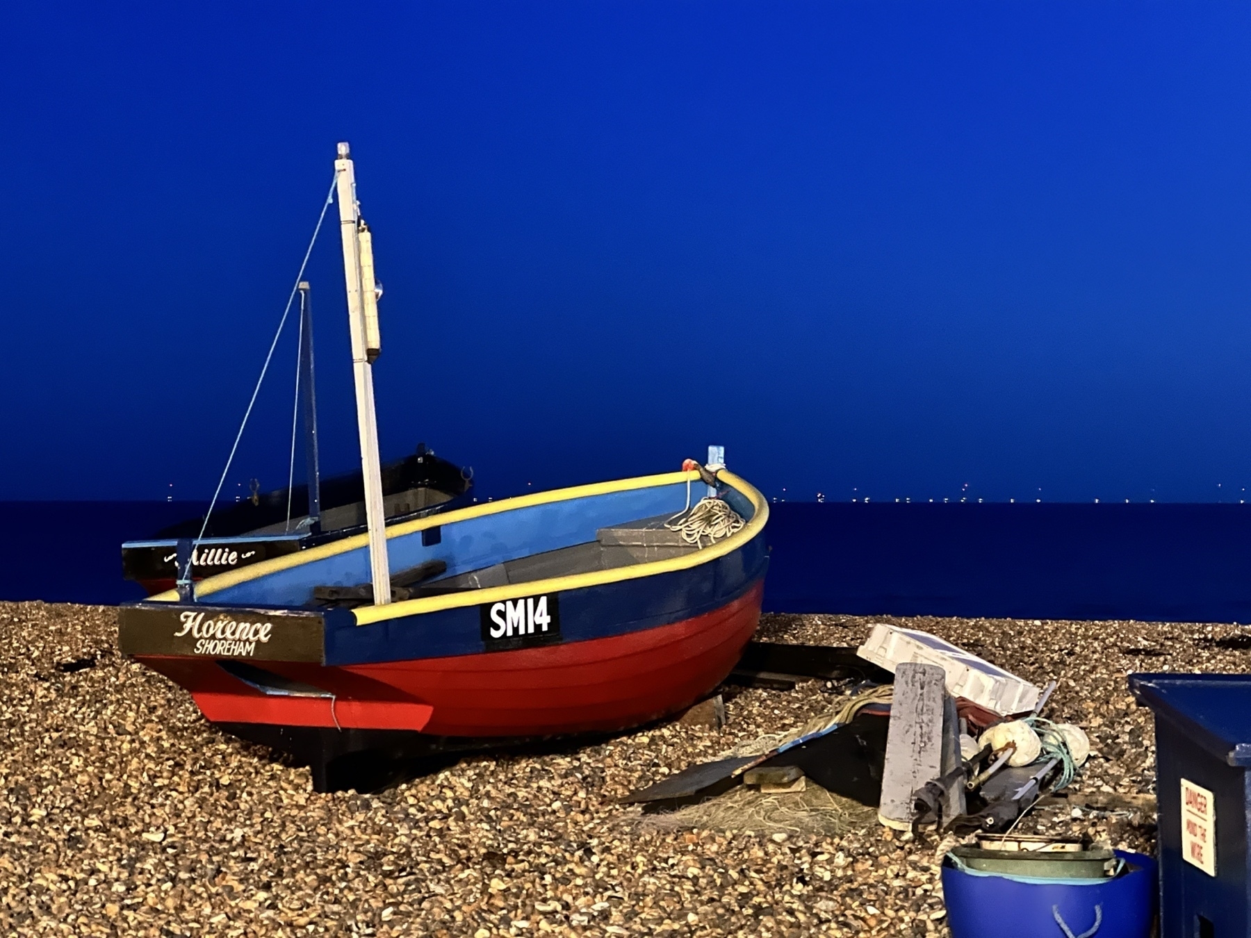 A fishing boat on the shore at Worthing, at night. 