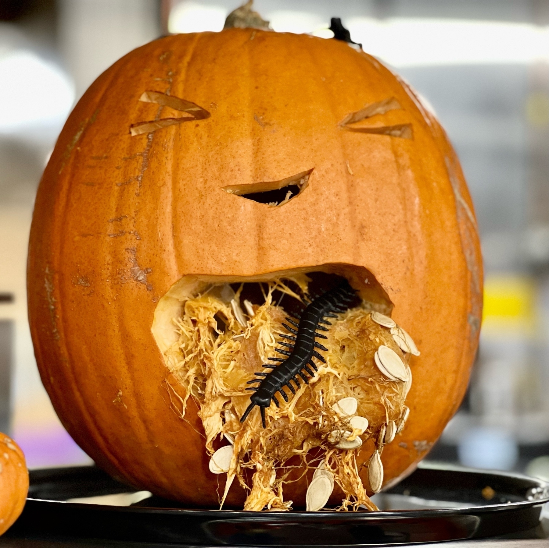 A Halloween pumpkin "vomiting" leaves. 