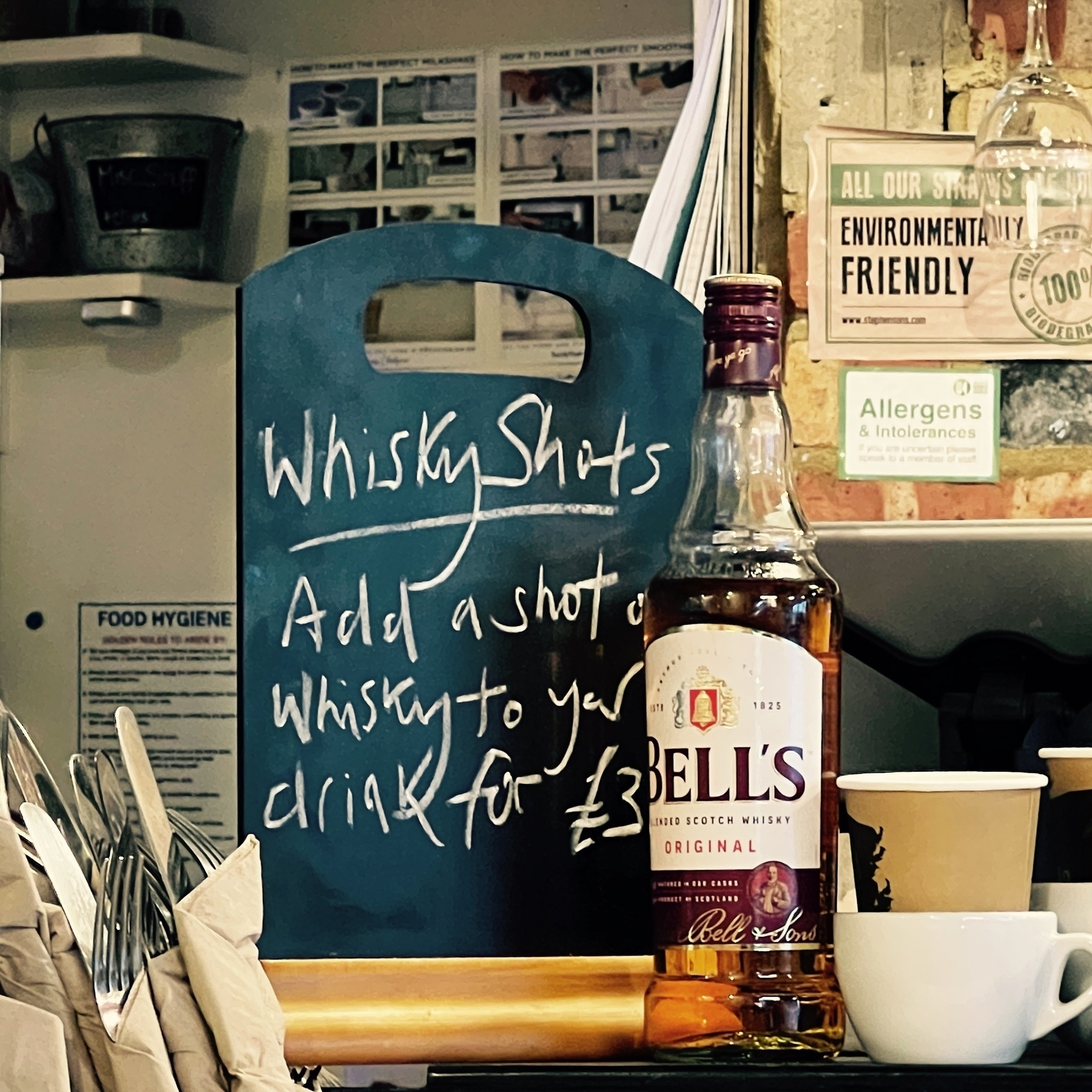 A sign iffering a shot of whisky in your drink for £3.