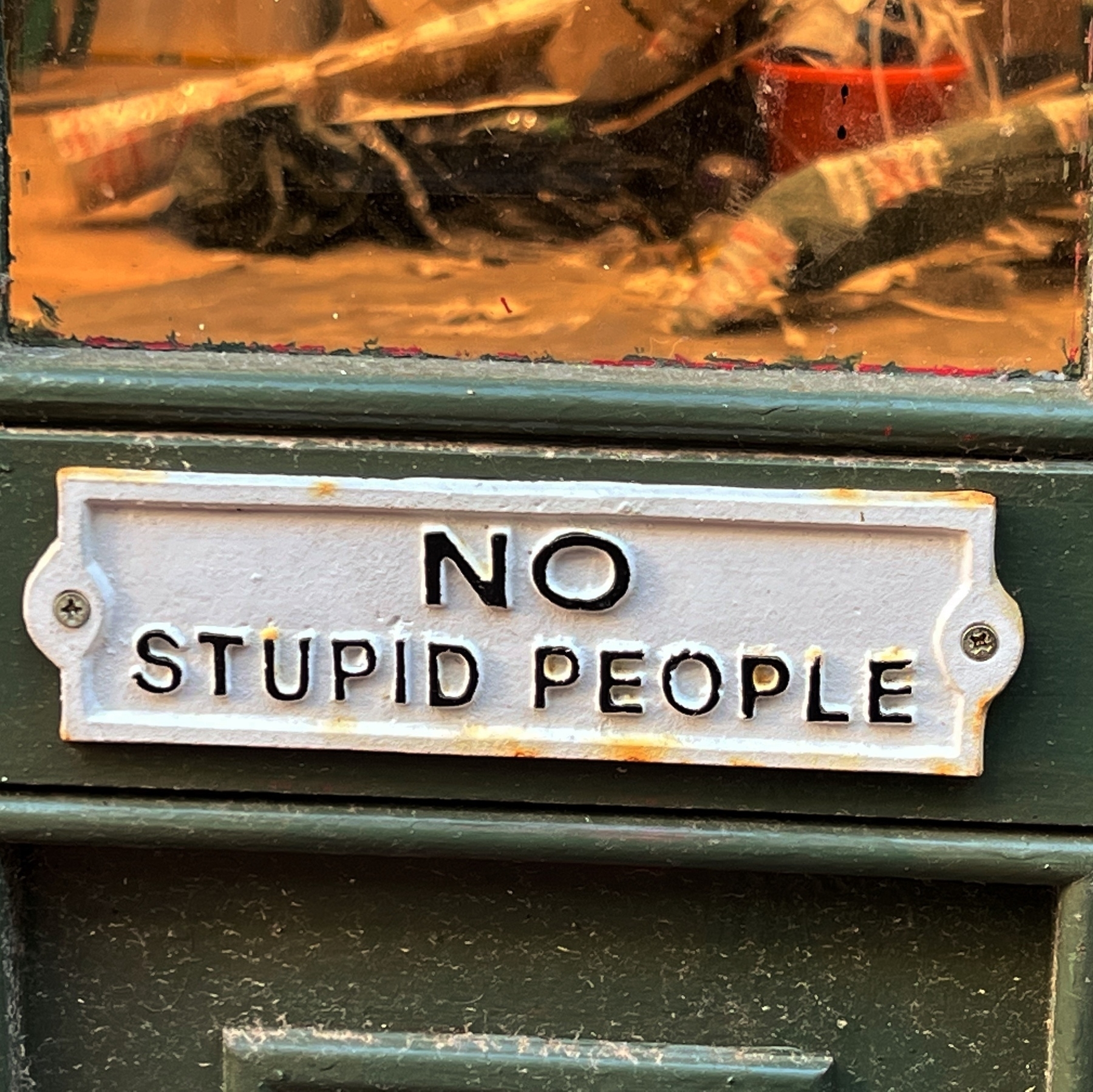 A sign on a door reading "no stupid people".