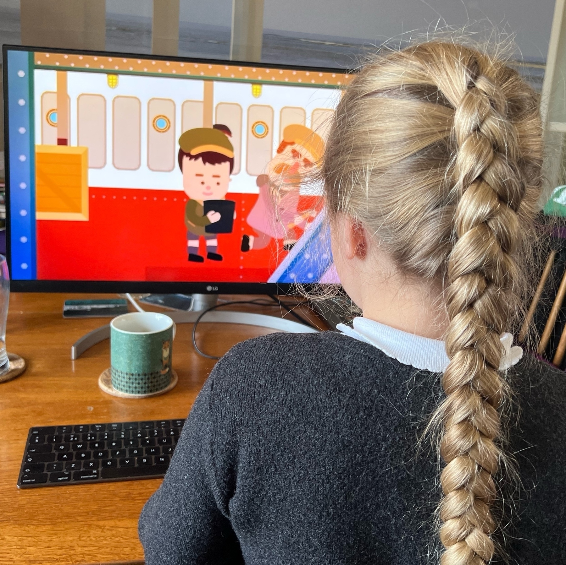 A girl doing home learning on a Mac 
