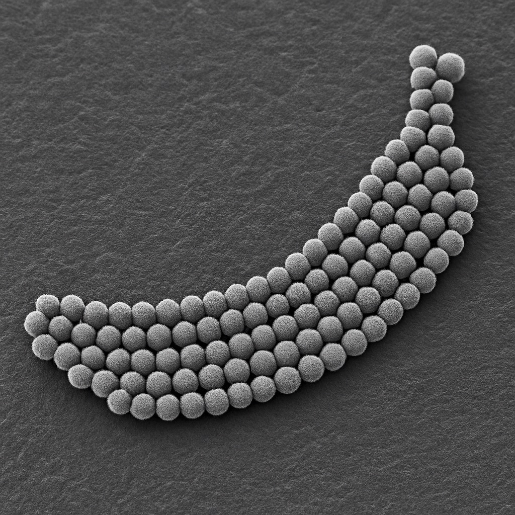 An AI-generated image of atoms arranged in the shape of a banana as if it came from an electron scanning microscope