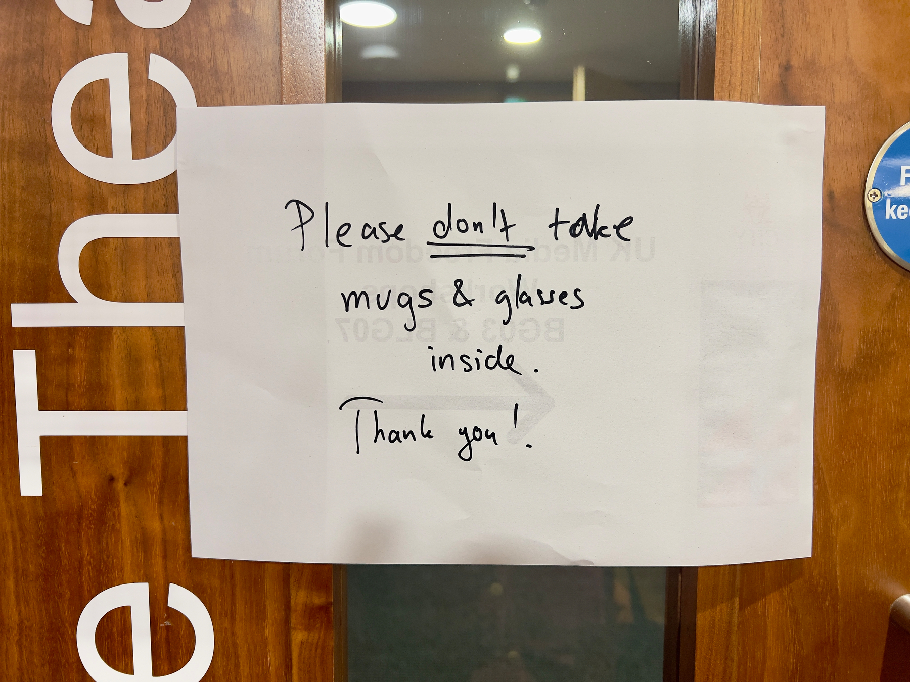 A sign on a door requests not to take mugs and glasses inside.