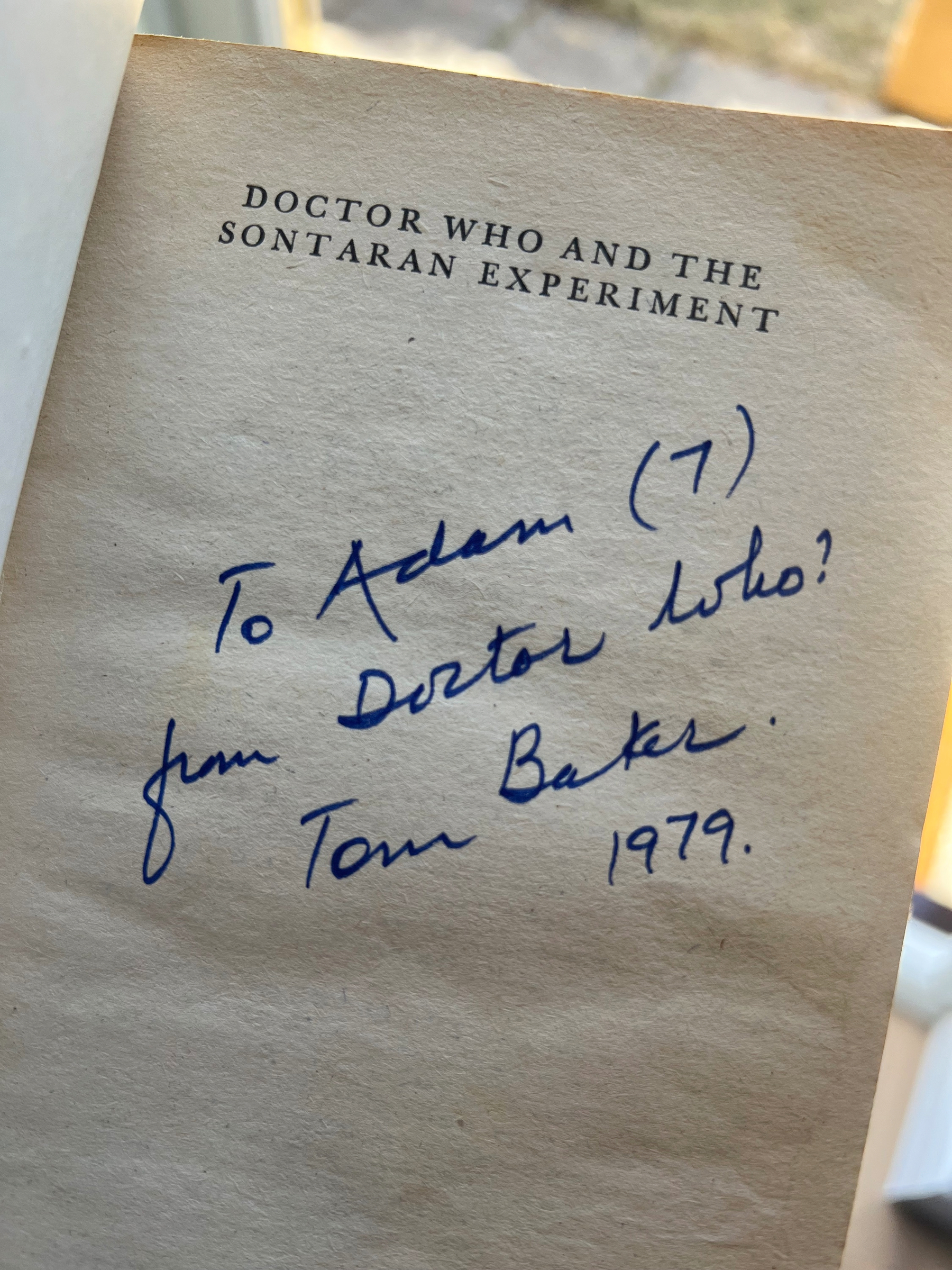 A signed inscription by Tom Baker in a copy of Doctor Who and the Sontaran Experiment is addressed to Adam and dated 1979.