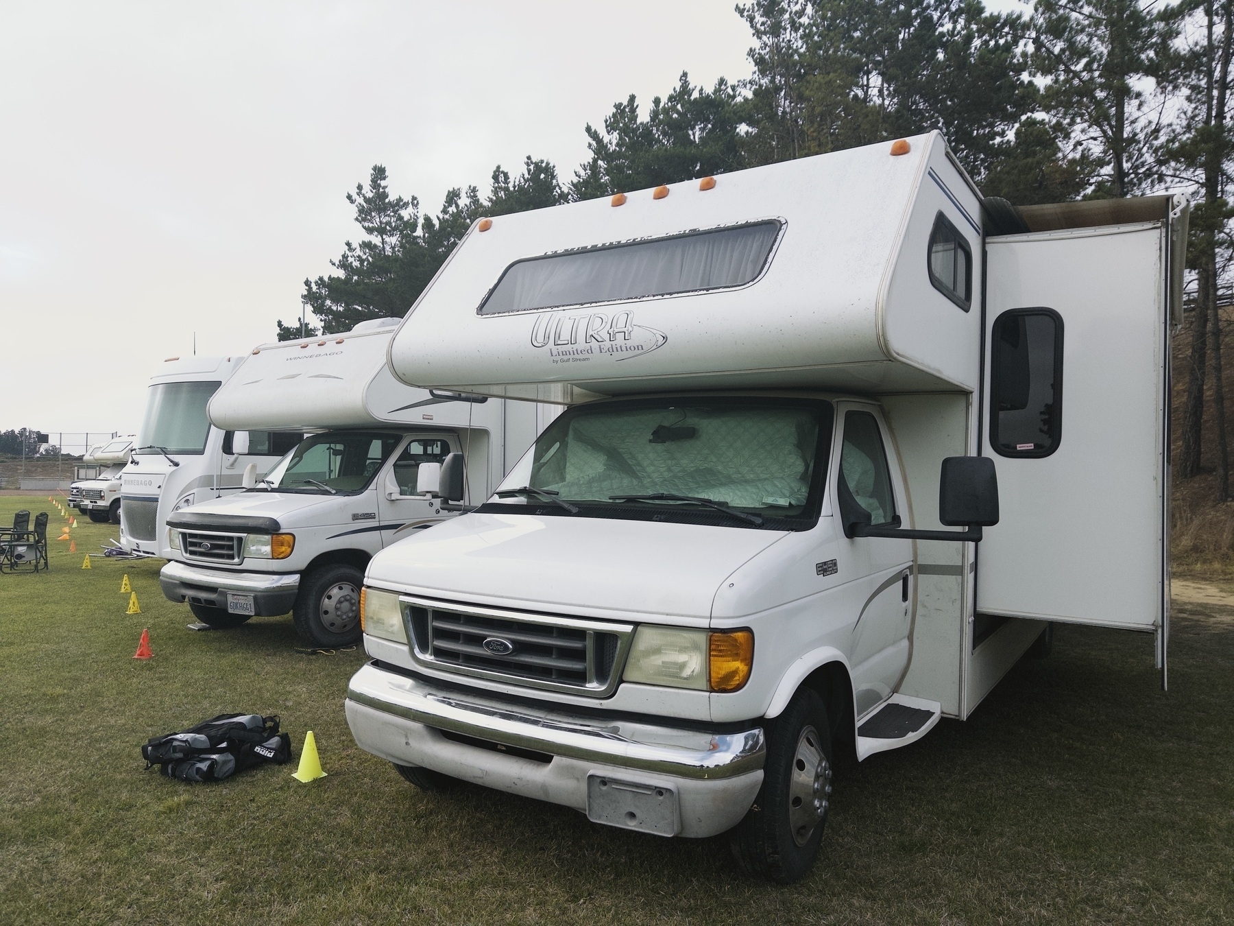 A row of RVs at a dog agility event.
