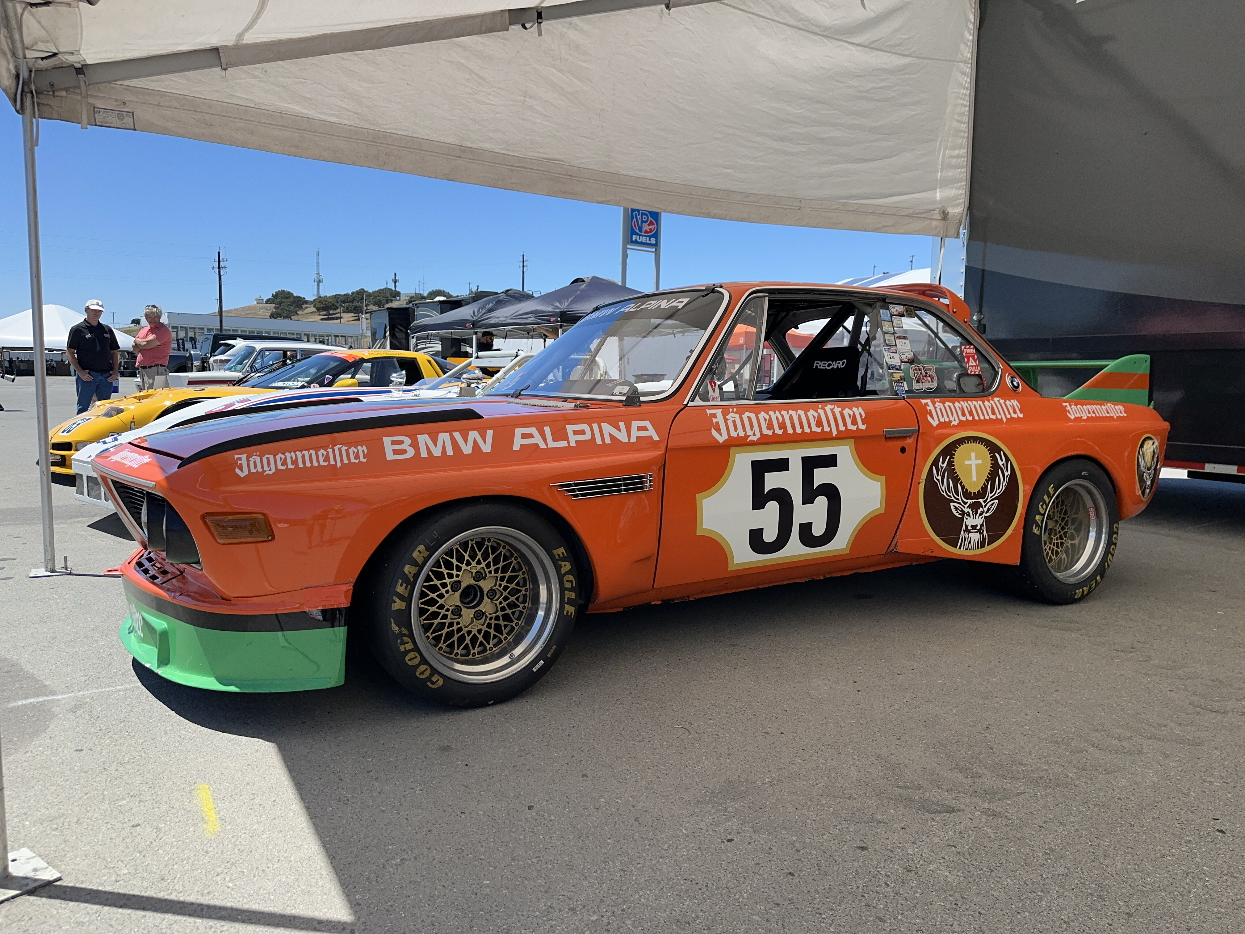 A BMW Alpina CSL race car in a very striking orange and green Jäegermeister livery