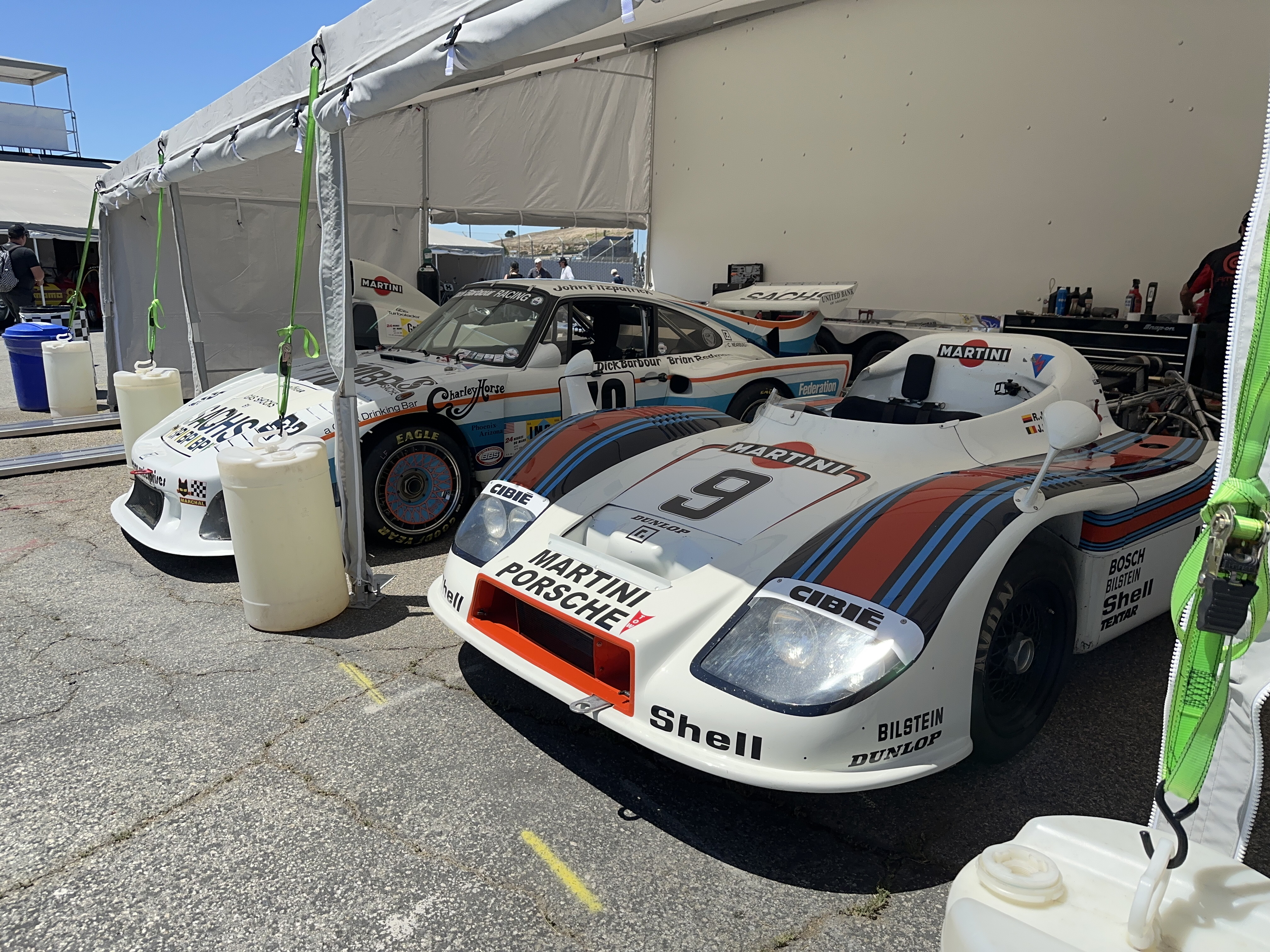 A slant-nose 911 race car and a striking Spyder LeMans race car in Porsche-Martini livery