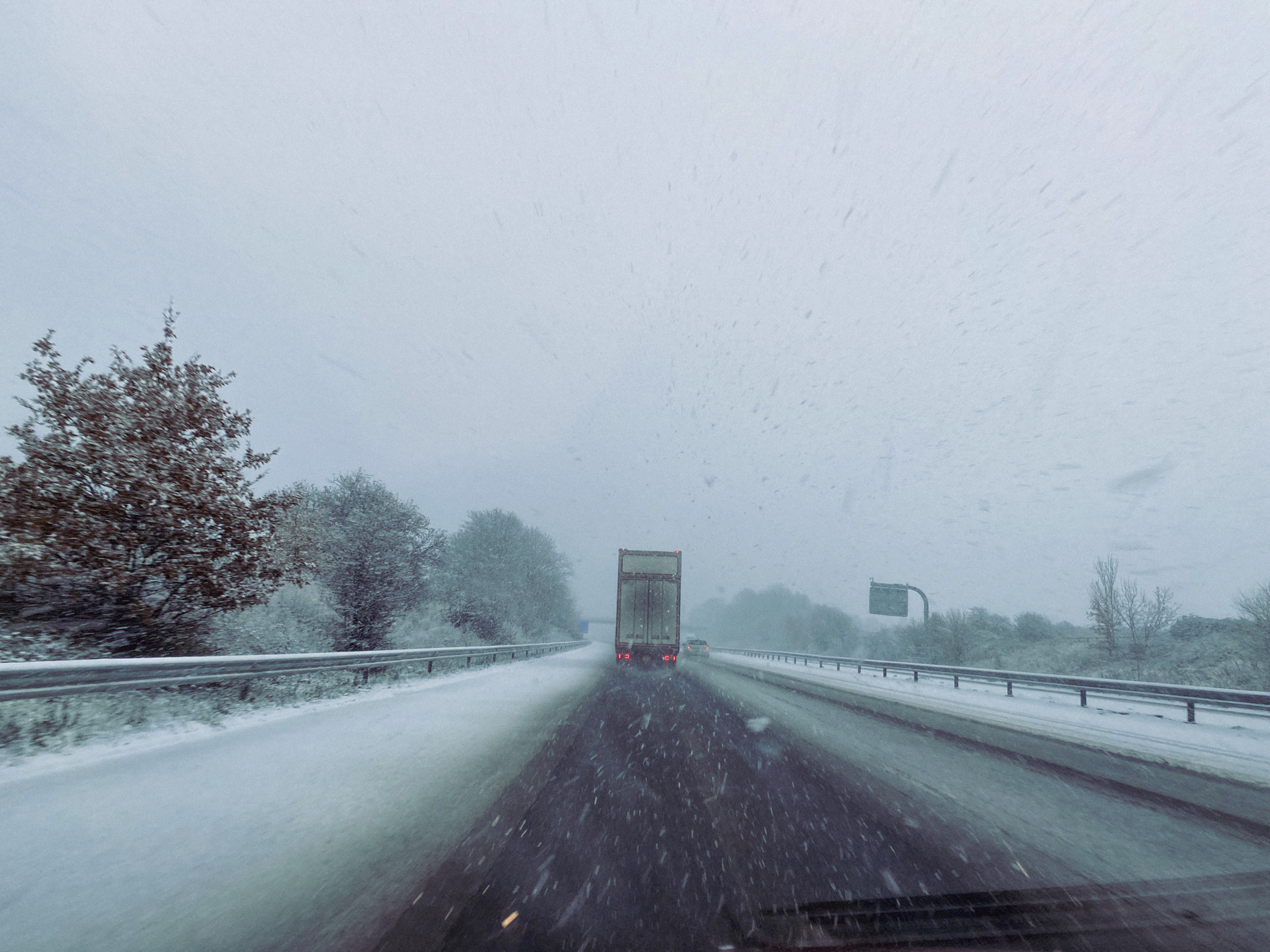 Lorry and car on a snow covered motorway