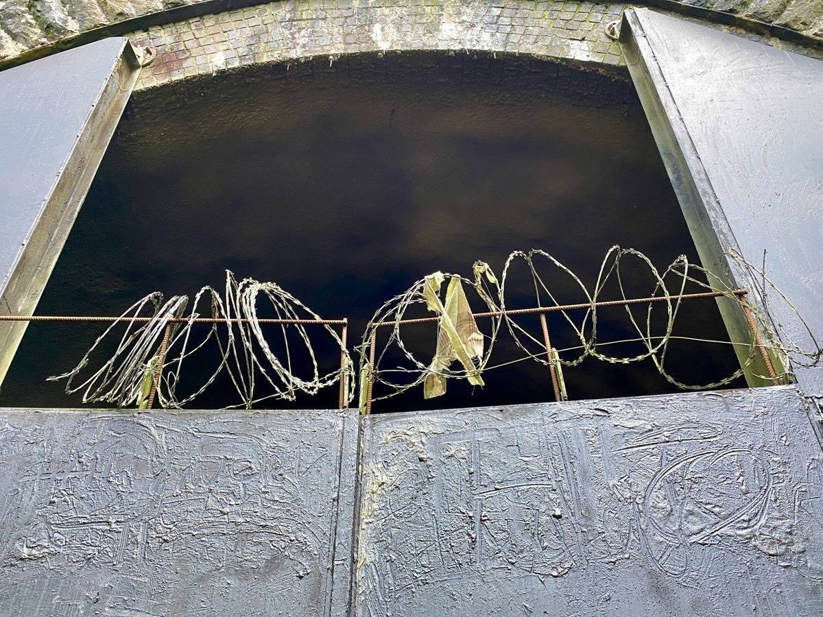Barbed wire over tunnel entrance