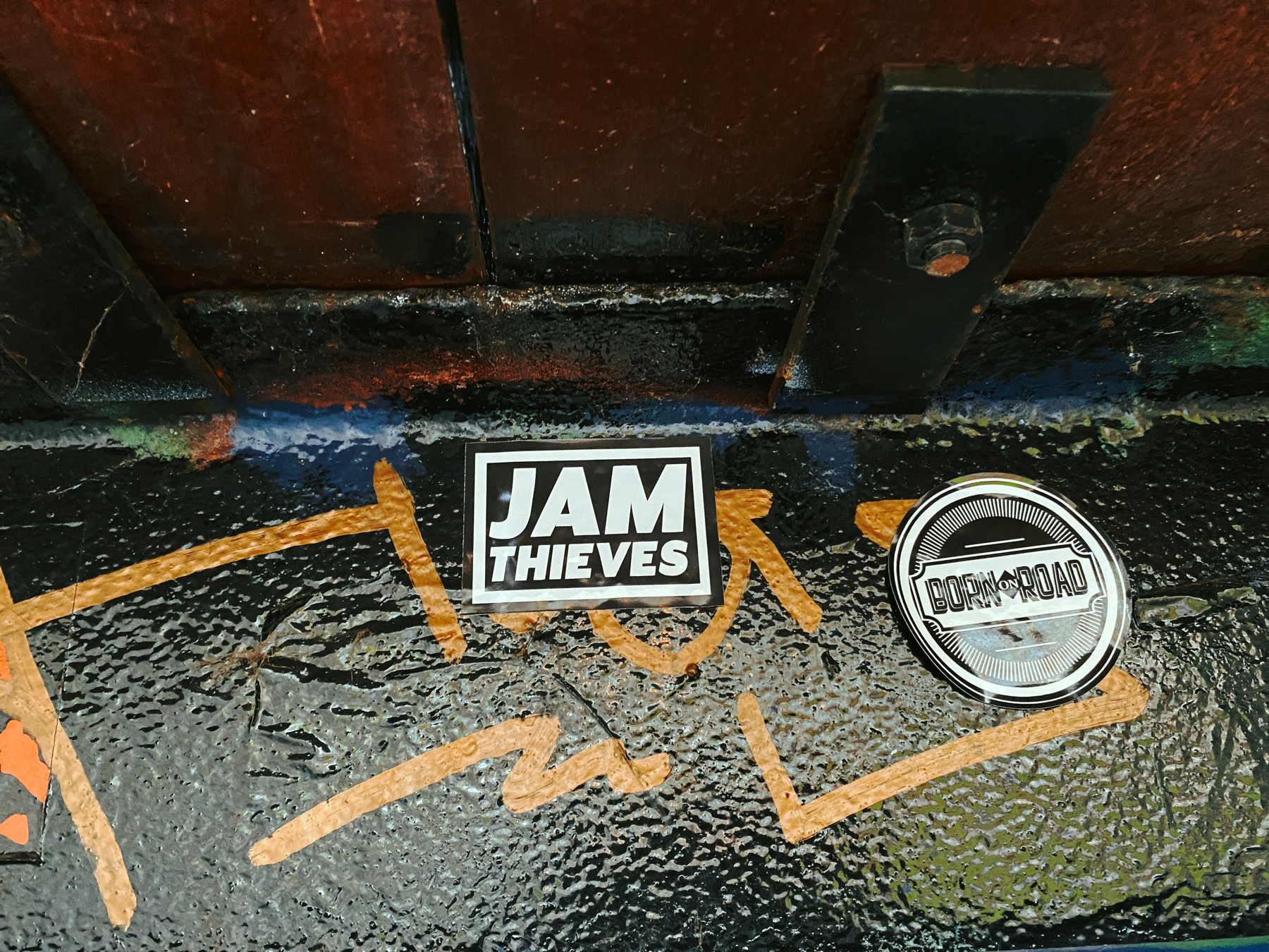 Two stickers on painted steel reading Jam Thieves and Born on the Road
