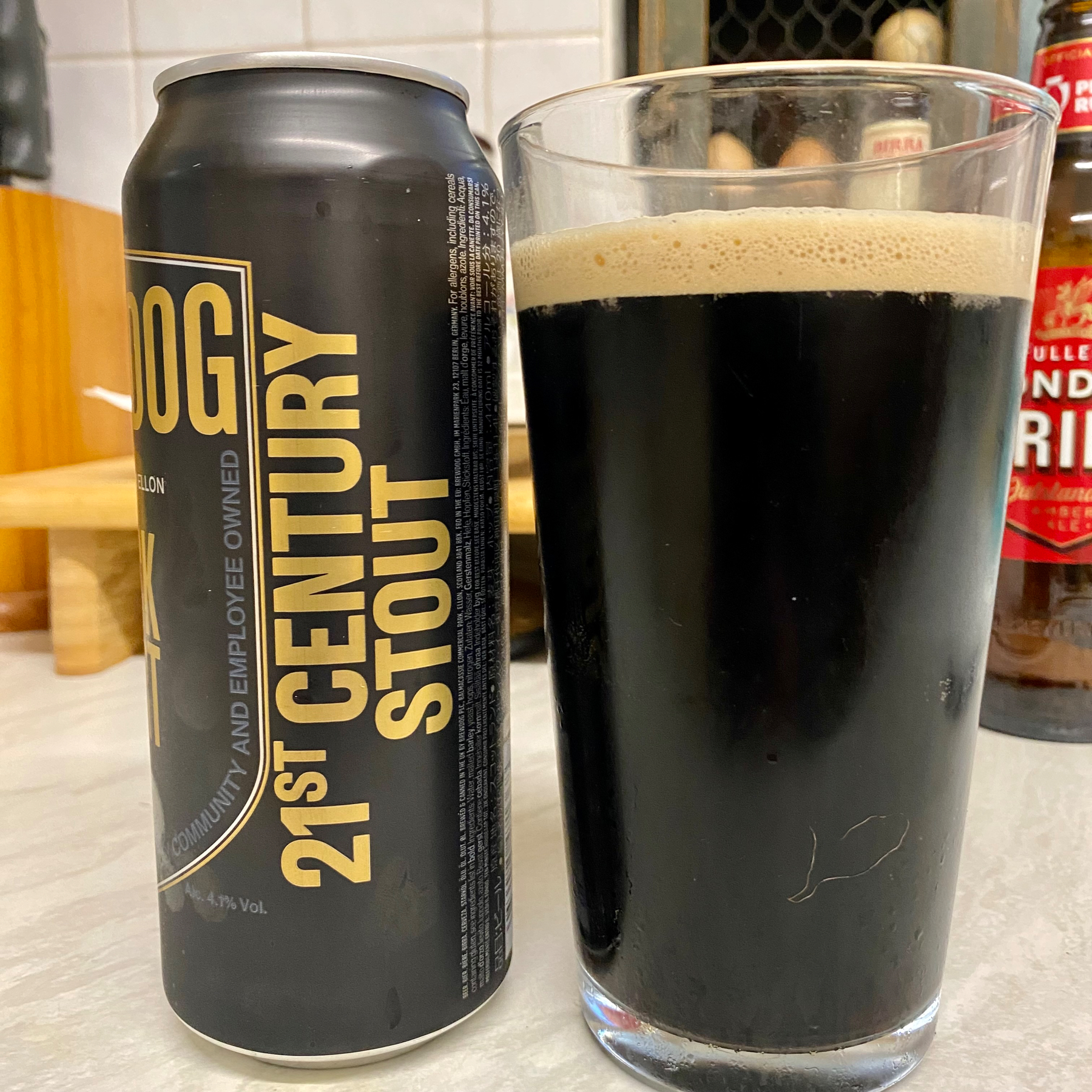 Can and pint glass of stout
