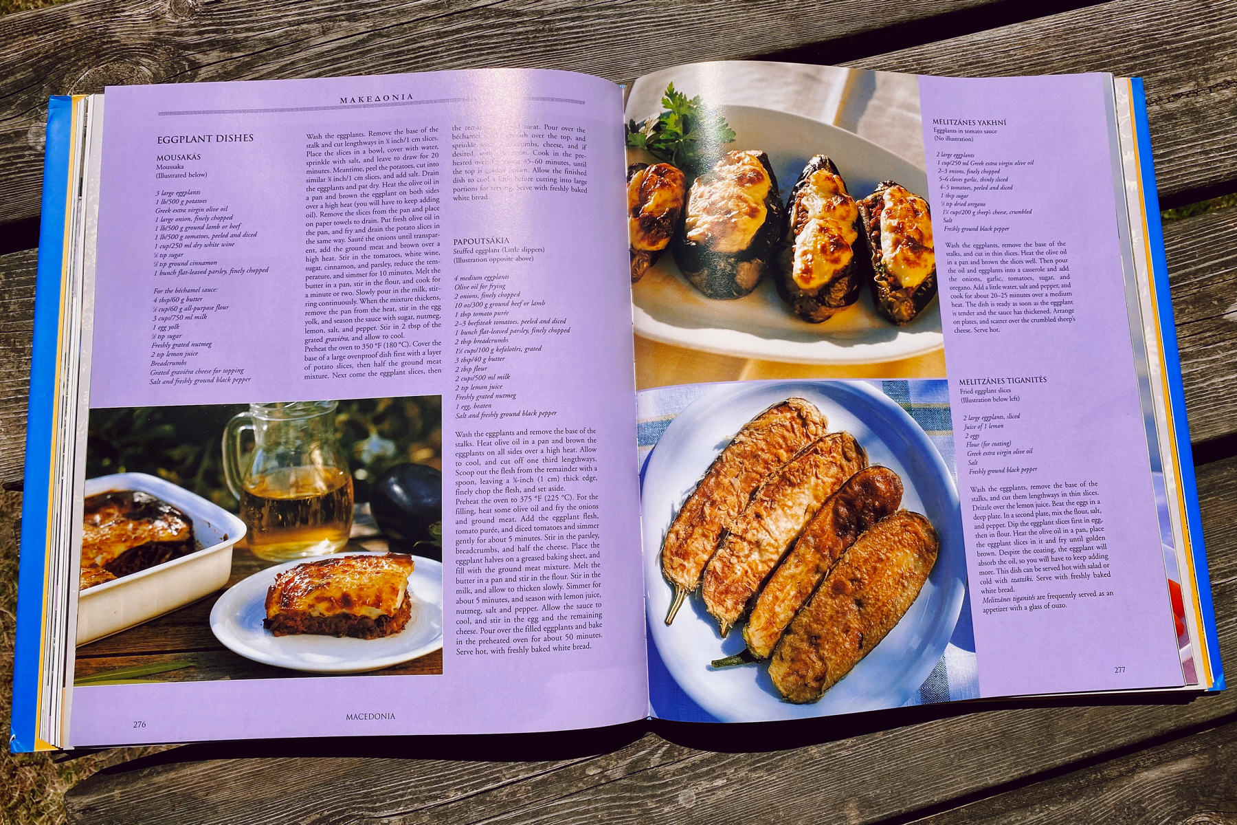 Open Greek cookery book showing eggplant recipes
