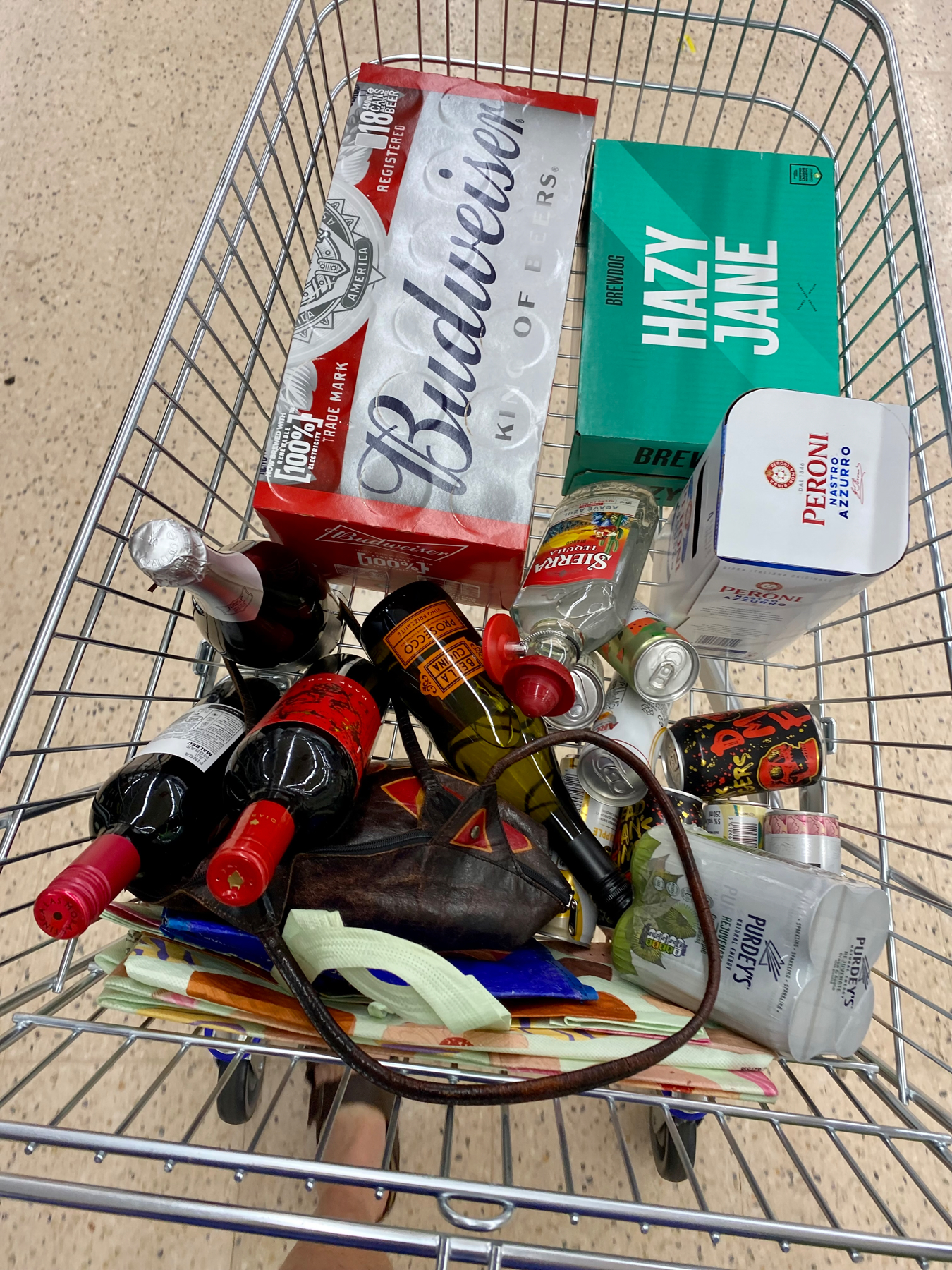 Supermarket trolley full of wine, beer and tequila