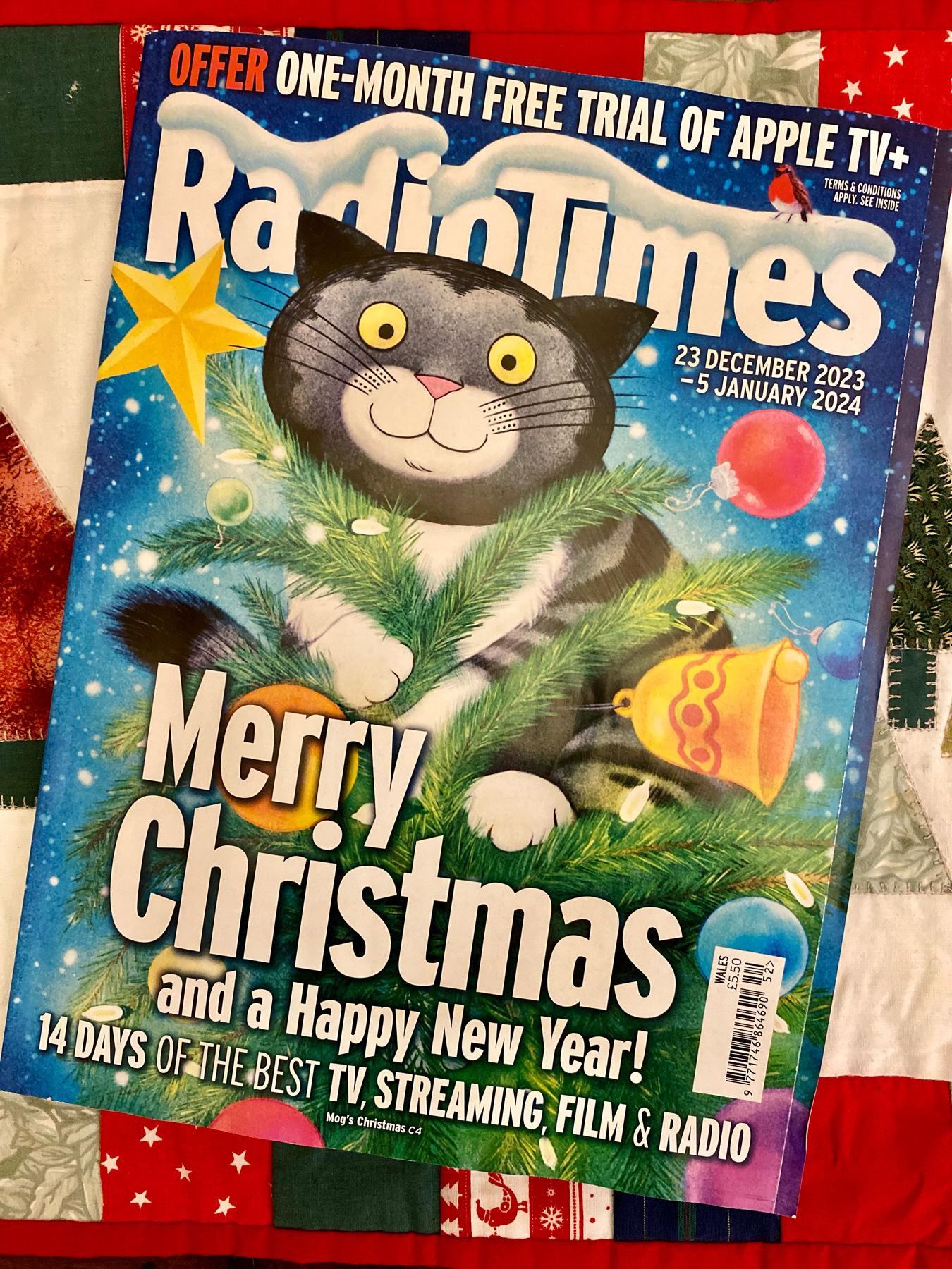 A festive Radio Times magazine cover with dates December 23, 2023, to January 5, 2024, featuring a cartoon illustration of a black and white cat on a decorated Christmas tree.