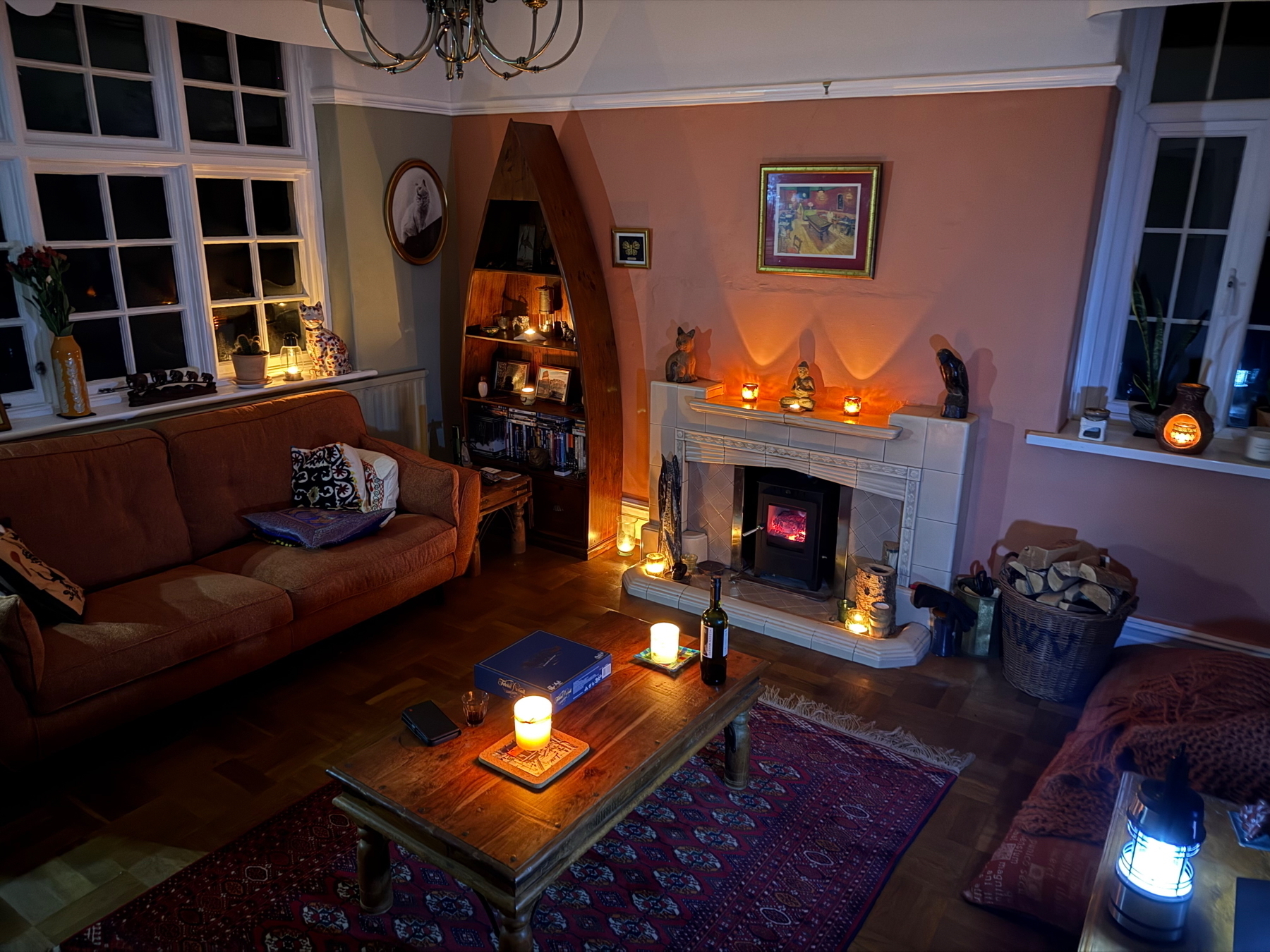 Candlelit lounge with a game and wine on a coffee table