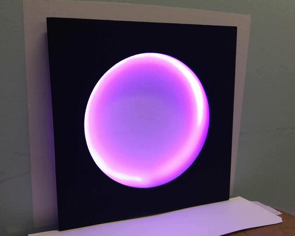 A glowing purple circle is centered in a black square panel against a light-colored wall.