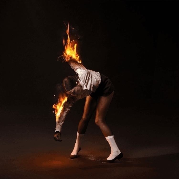 Album cover of St. Vincent - _All Born Screaming_. Annie Clark, contorted, arms on fire.