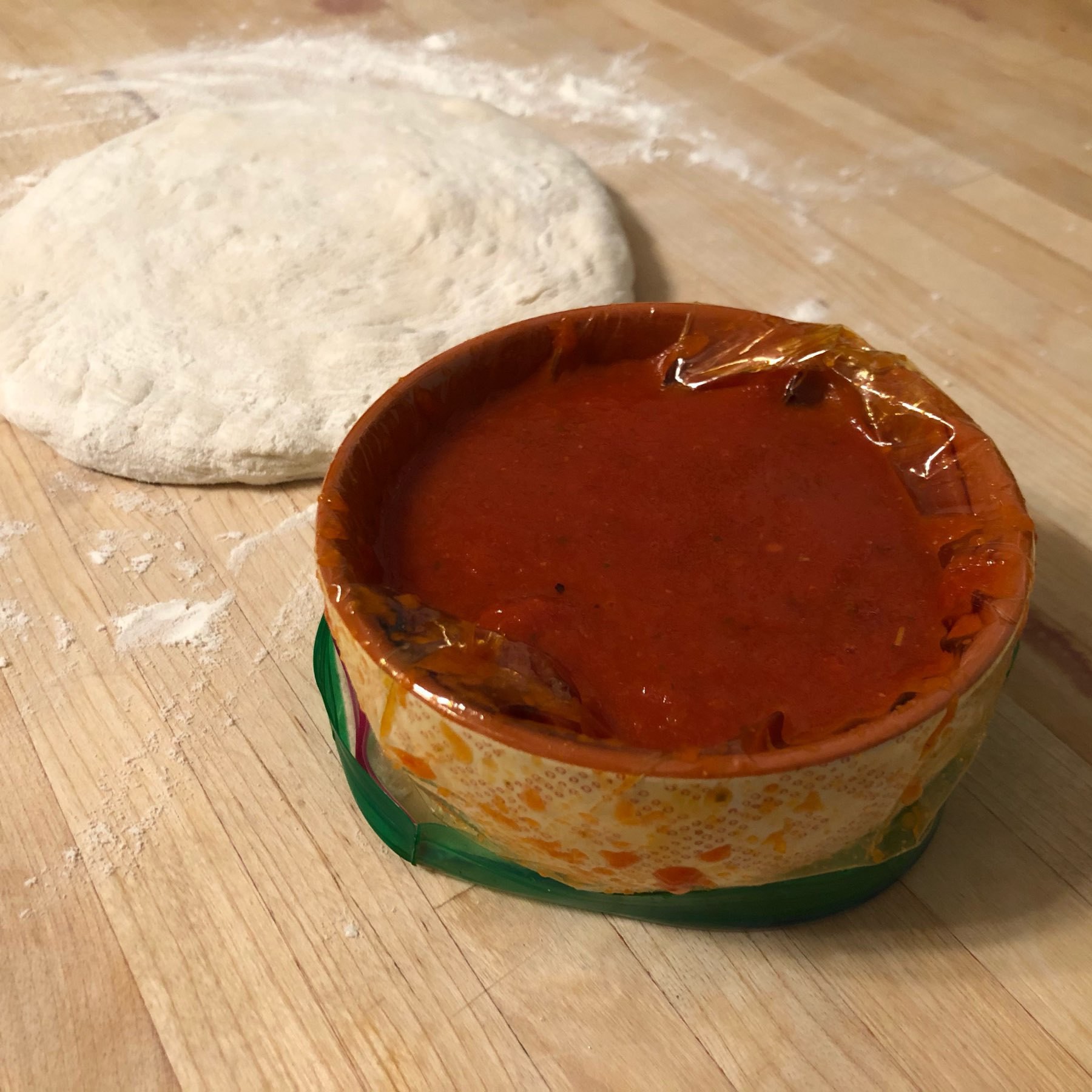 ceramic bowl with platic ziploc bag fit to hold thawed sauce