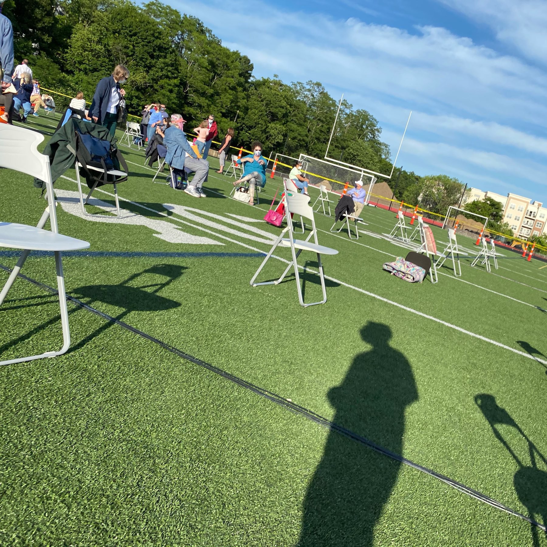 Shot of chairs spaced widely on a football field