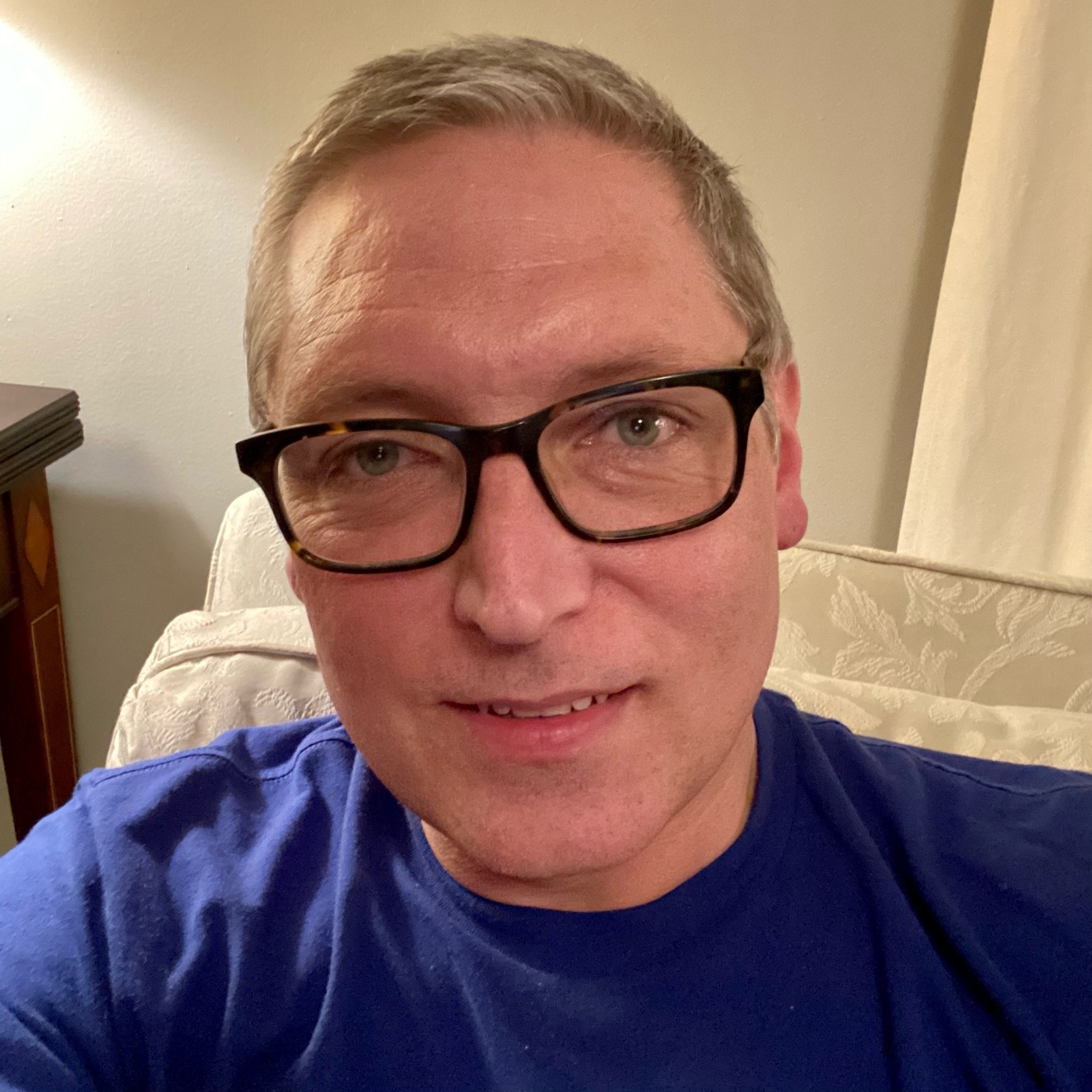self portrait in blue t-shirt, clean-shaved, short hair, white complexion