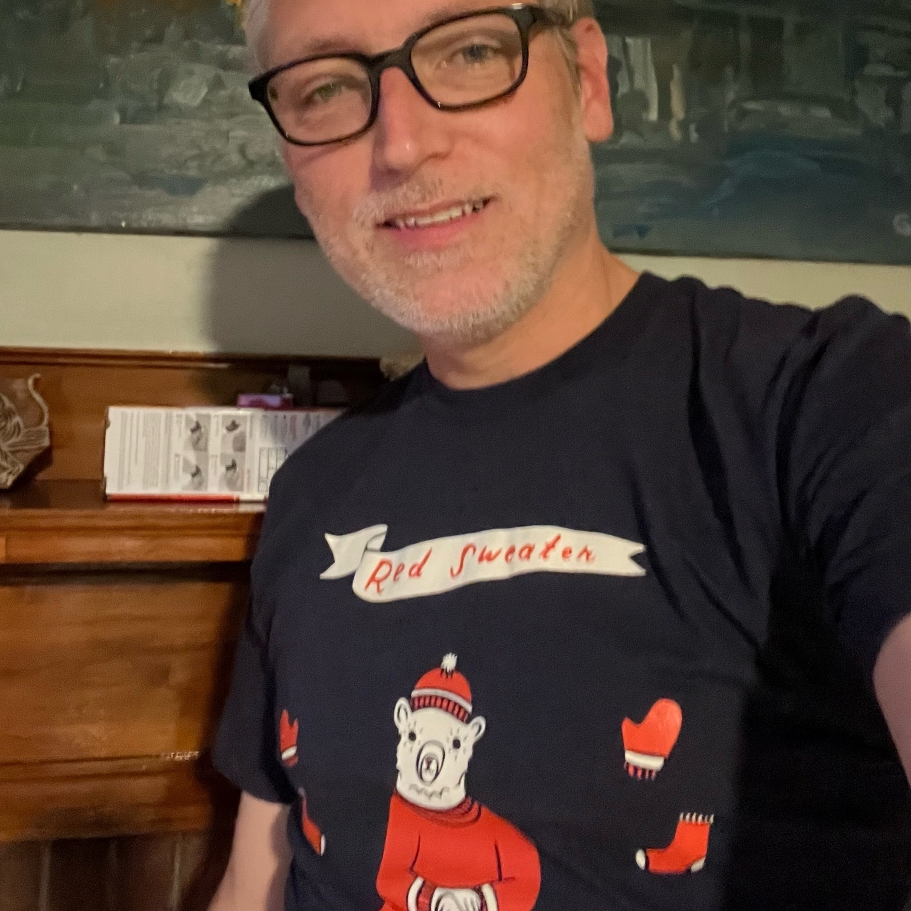 selfie wearing a shirt with "red sweater" text and a picture of a polar bear wearing a red sweater